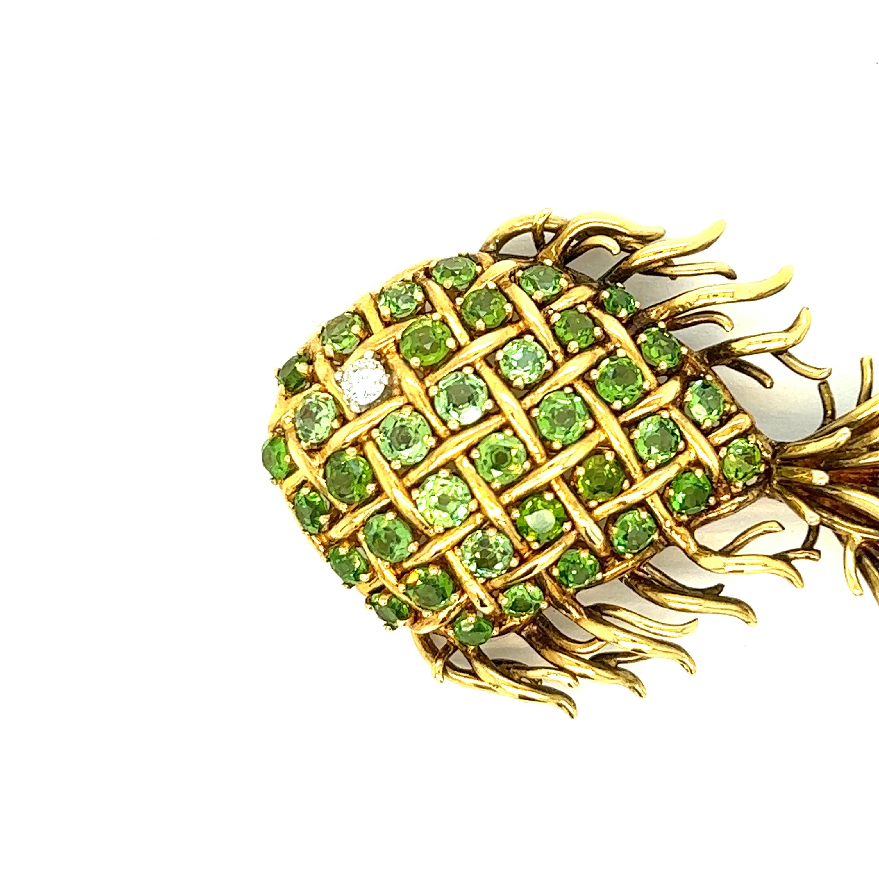 Tiffany & Co. demantoid garnet and diamond fish brooch 

Round-cut demantoid garnets of approximately 1.60 carats, one round brilliant-cut diamond, 18 karat yellow gold; marked Tiffany & Co., 18k

Size: width 1.88 inches, length 1.25 inches
Total