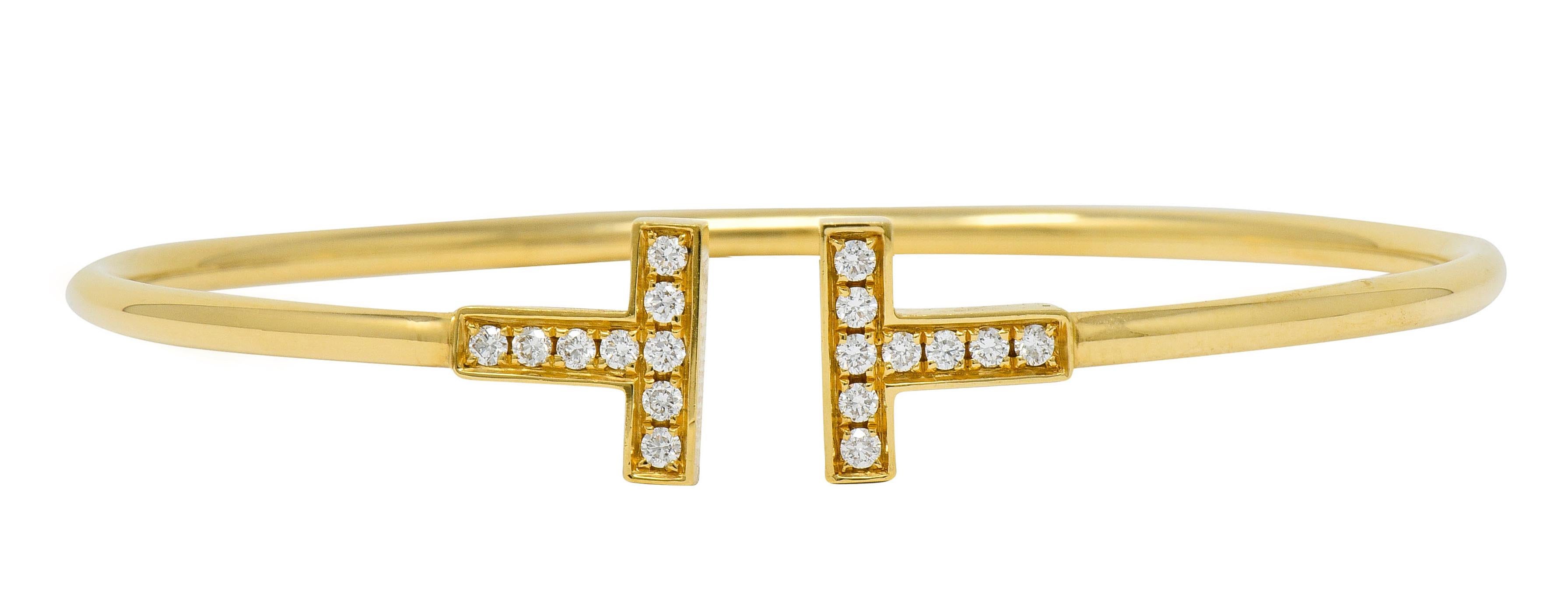 Thin and flexible cuff style bracelet that terminates as two polished gold T's

Terminals are bead set with round brilliant cut diamonds weighing approximately 0.22 carat; eye-clean and white

Signed T & Co. Italy

Stamped AU750 for 18 karat