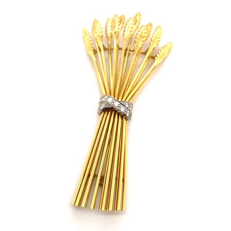 A Tiffany & Co. diamond 18 karat yellow gold platinum wheat sheaf brooch, circa 1970.

This iconic brooch by Tiffany & Co. is beautifully crafted in 18 karat yellow gold, featuring a realistically modelled wheat sheaf, fastened with a platinum