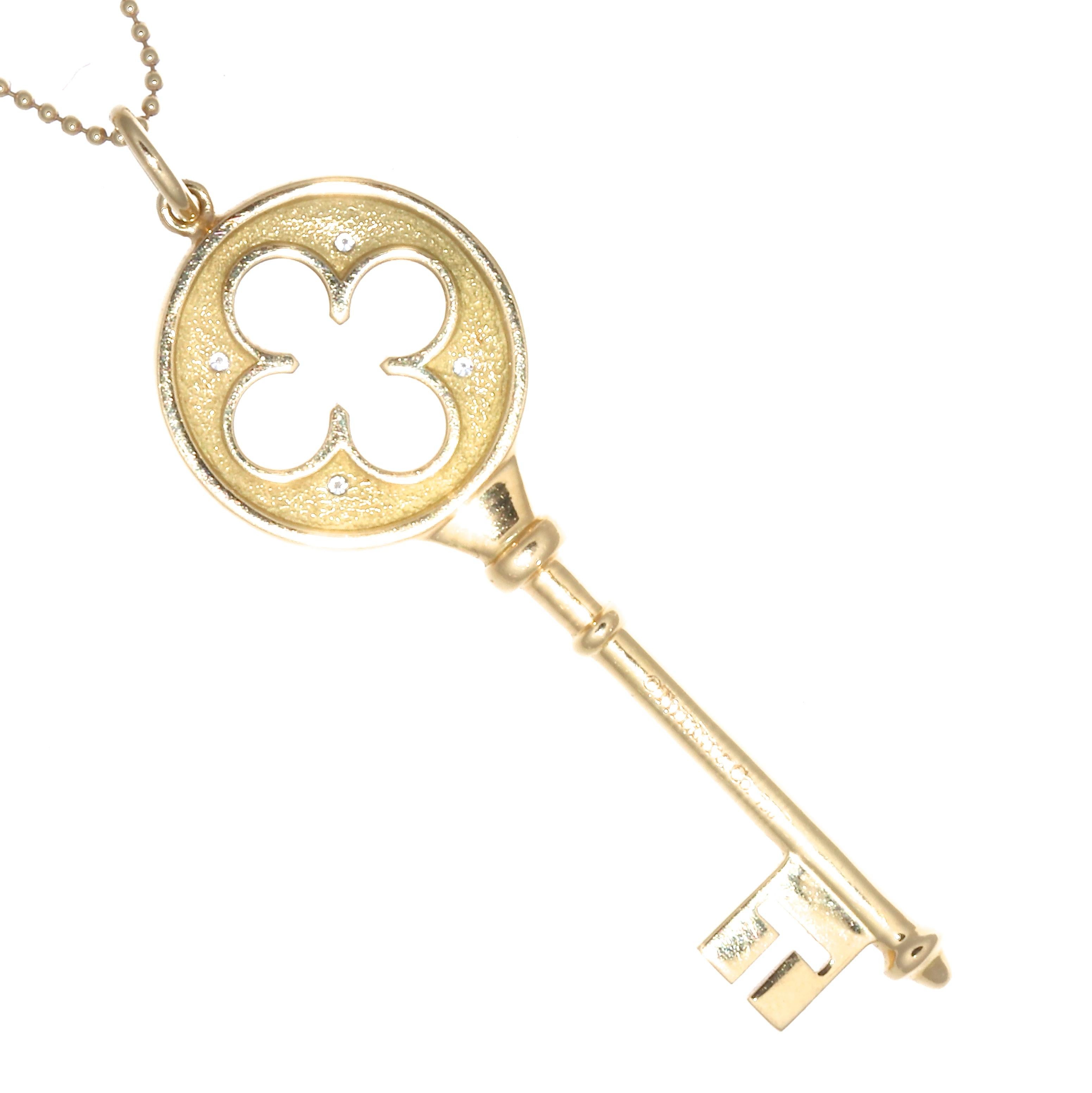 The key to the city, her heart, success and happiness. Tiffany & Co. diamond 18k gold key necklace. Featuring 4 round brilliant cut diamonds graded D,E color, VVS clarity. Circa 1980's. Both Signed Tiffany. pendant is 2 inches x 3/4 inches. Necklace