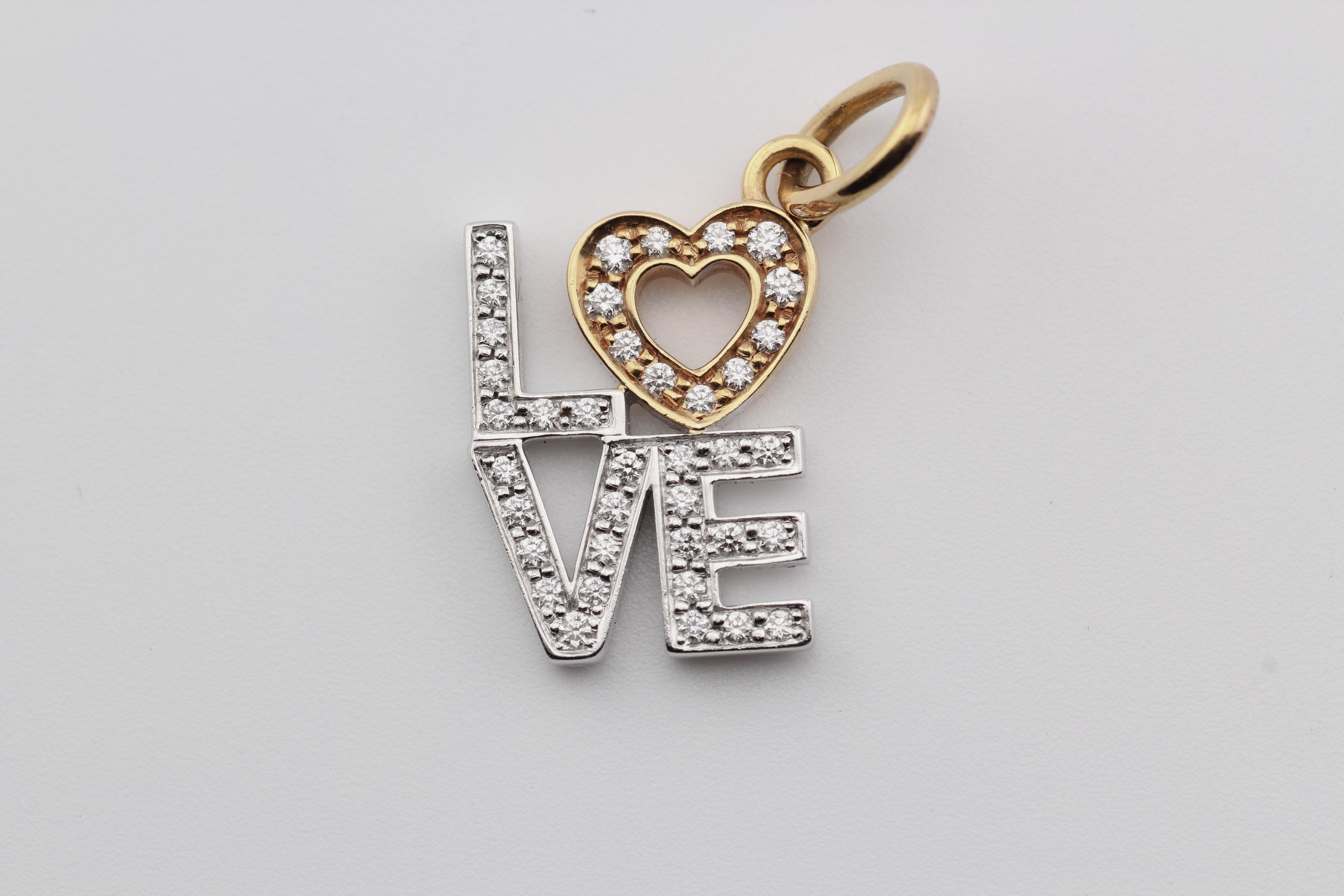 Presenting the Tiffany & Co. Diamond 18K White and Pink Gold Love Charm Pendant—an enchanting declaration of affection and timeless elegance. Crafted by the renowned luxury house, Tiffany & Co., this pendant embodies the spirit of love with