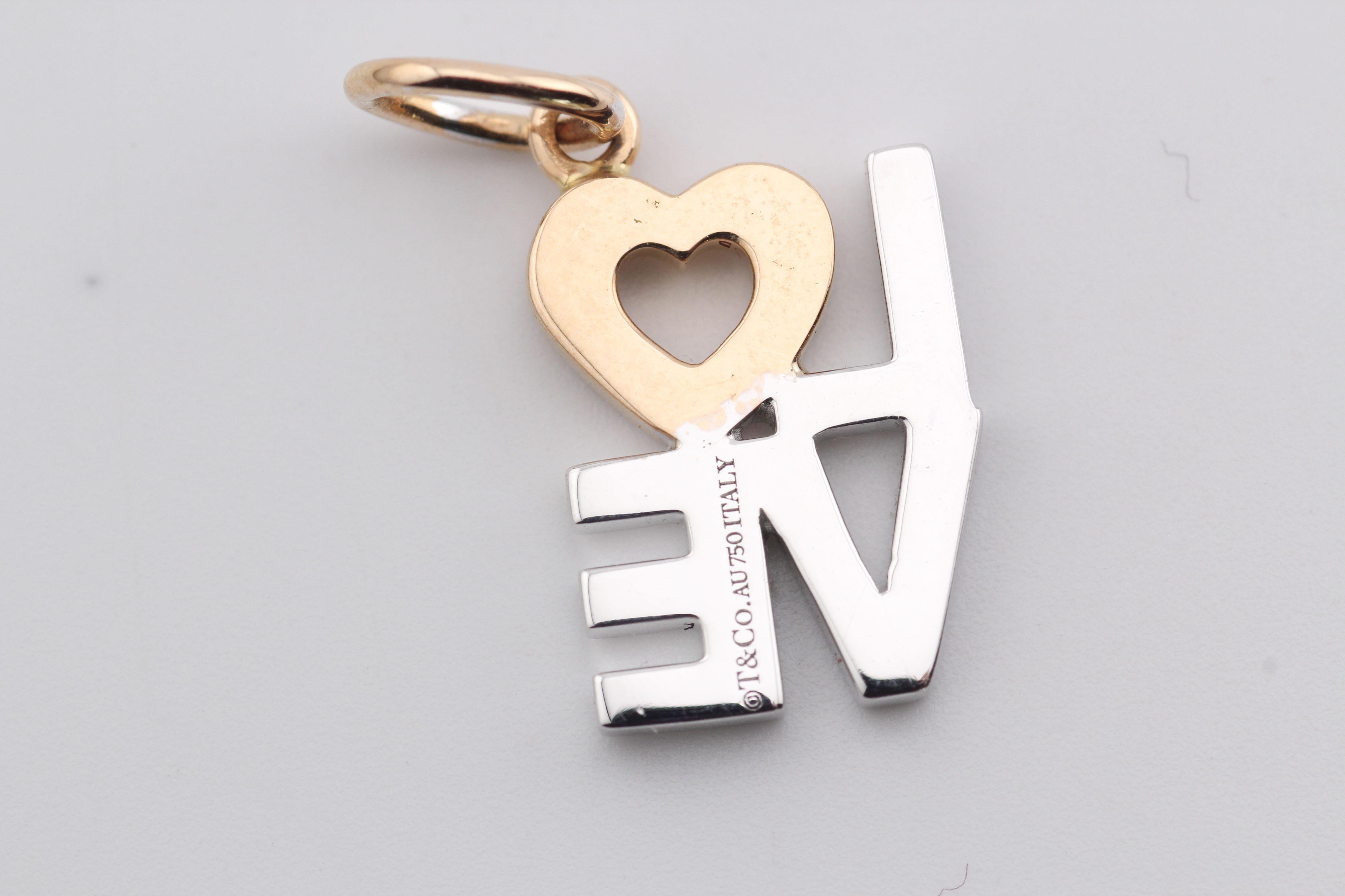 Presenting the Tiffany 
Co. Diamond 18K White and Pink Gold Love Charm Pendant—an enchanting declaration of affection and timeless elegance. Crafted by the renowned luxury house, Tiffany 
Co., this pendant embodies the spirit of love with