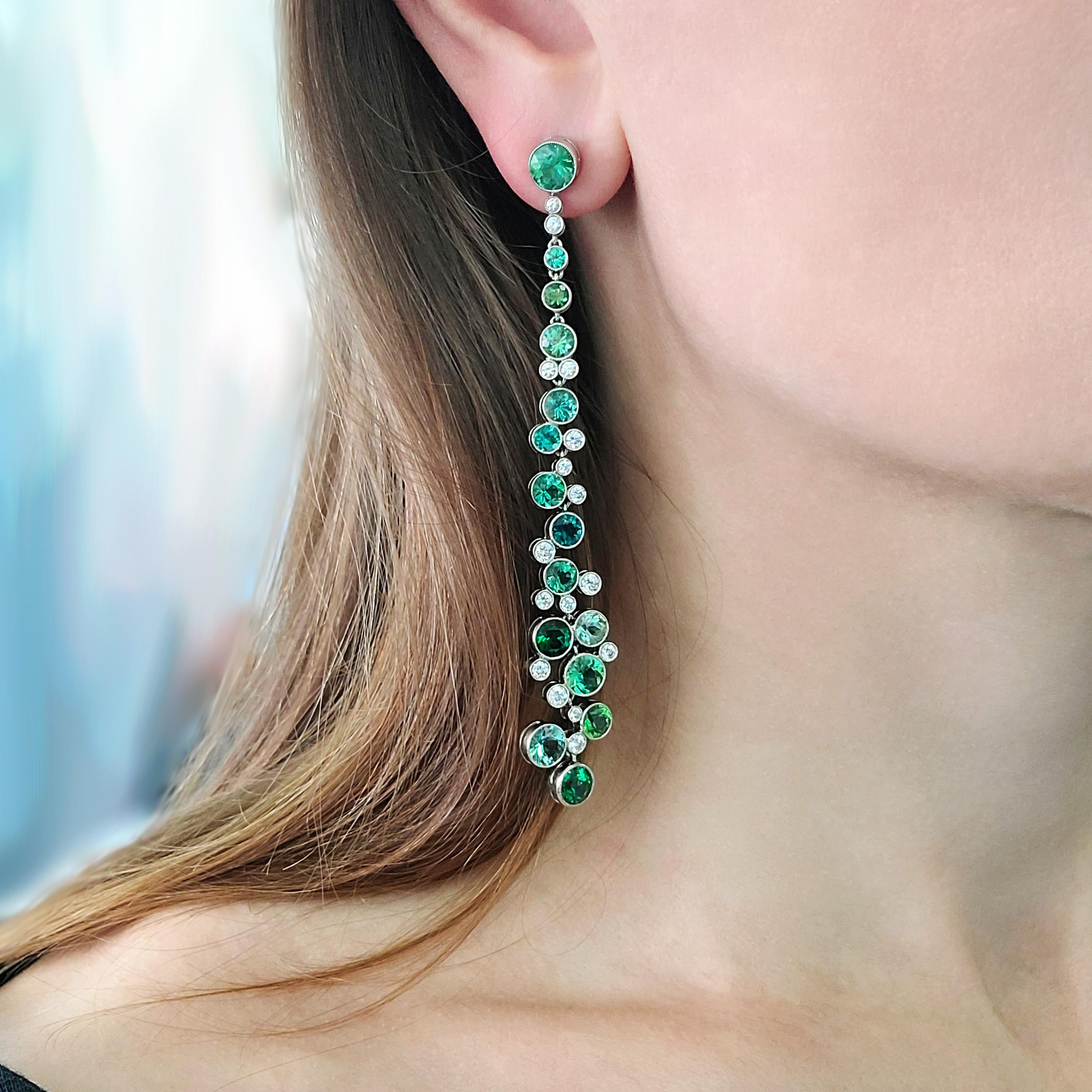 Tiffany & Co. Diamond And Green Tourmaline Drop
Earrings In Platinum. The earrings are bezel
set with 32 round brilliant cut diamonds with weight of approximately 1.69ct, color F-G, clarity VS,
and 30 round cut green tourmalines with
total weight of