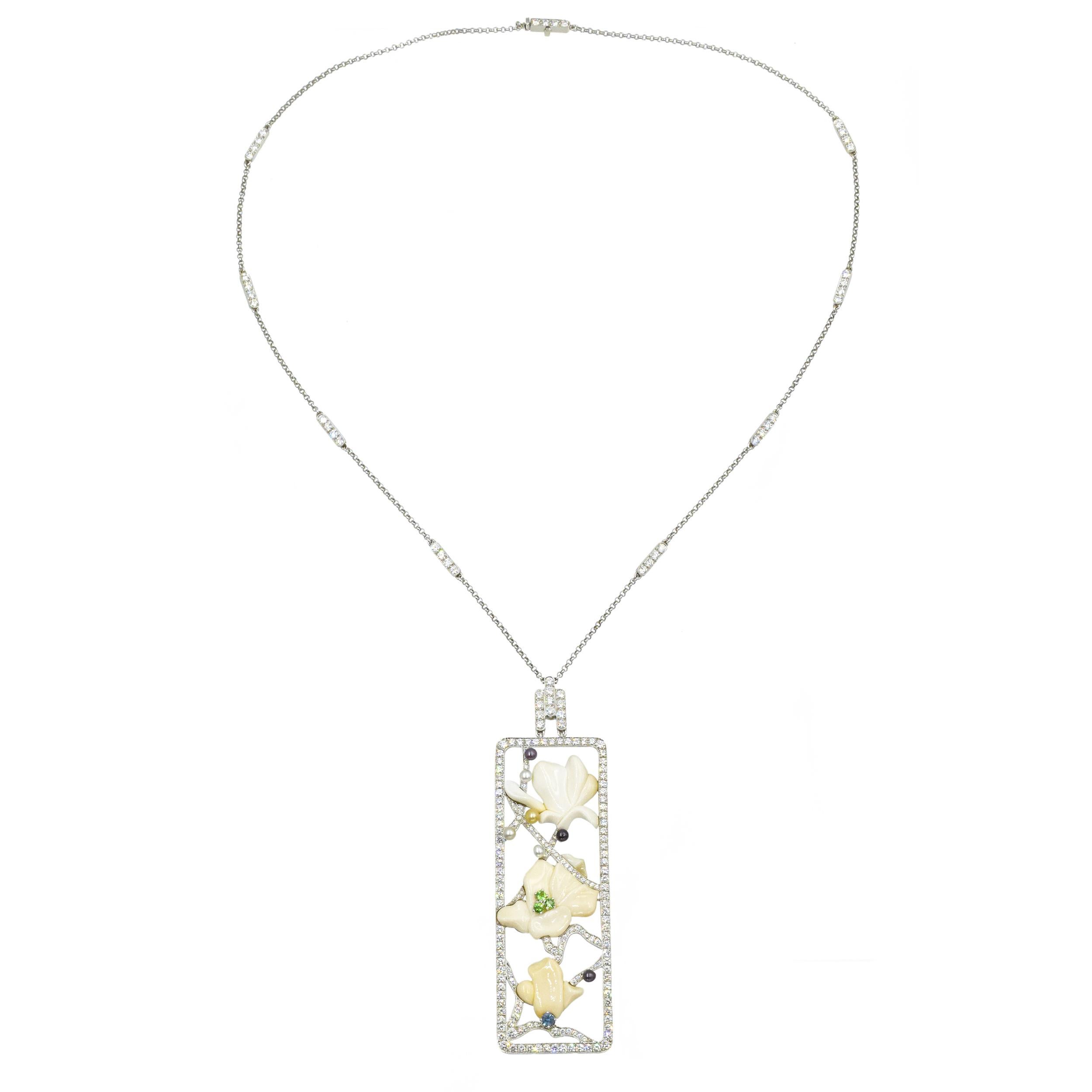 Tiffany & Co. Diamond And Multi-Gem 'Magnolia' Pendant Necklace In Platinum. This necklace is set with 222 round brilliant cut diamonds with a total weight of approximately 3.75ct - 4.0ct, color F-G, clarity VS, tsavorite garnets, a sapphire, seed