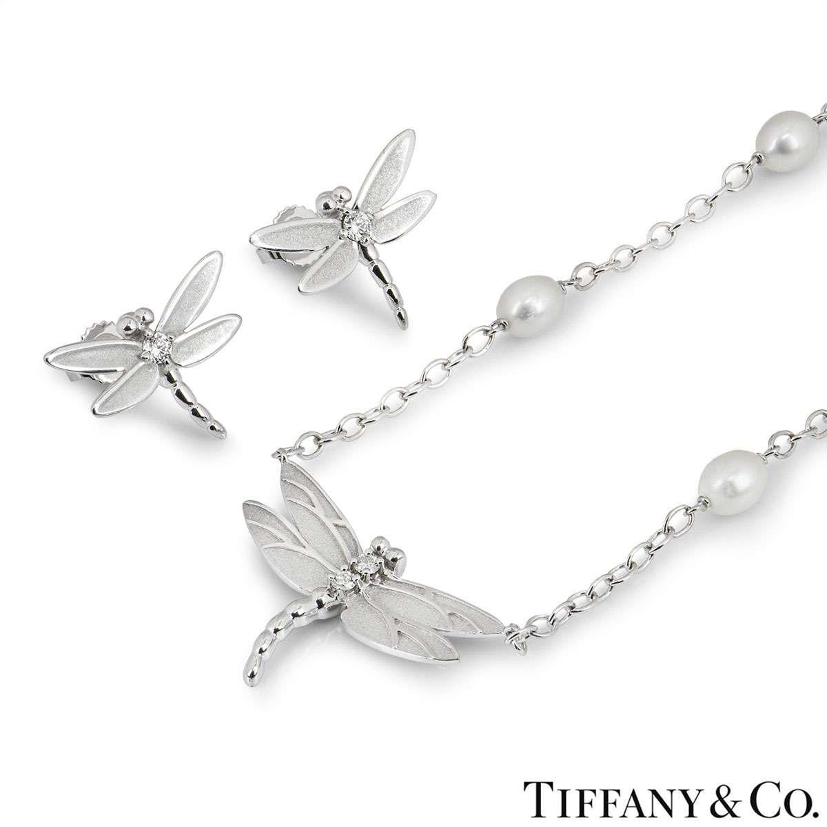 A beautiful necklace and earring suite by Tiffany & Co. The earrings are each set with a single round brilliant cut diamond in the centre of the Dragonfly and feature post and butterfly back fittings. The necklace has two round brilliant cut