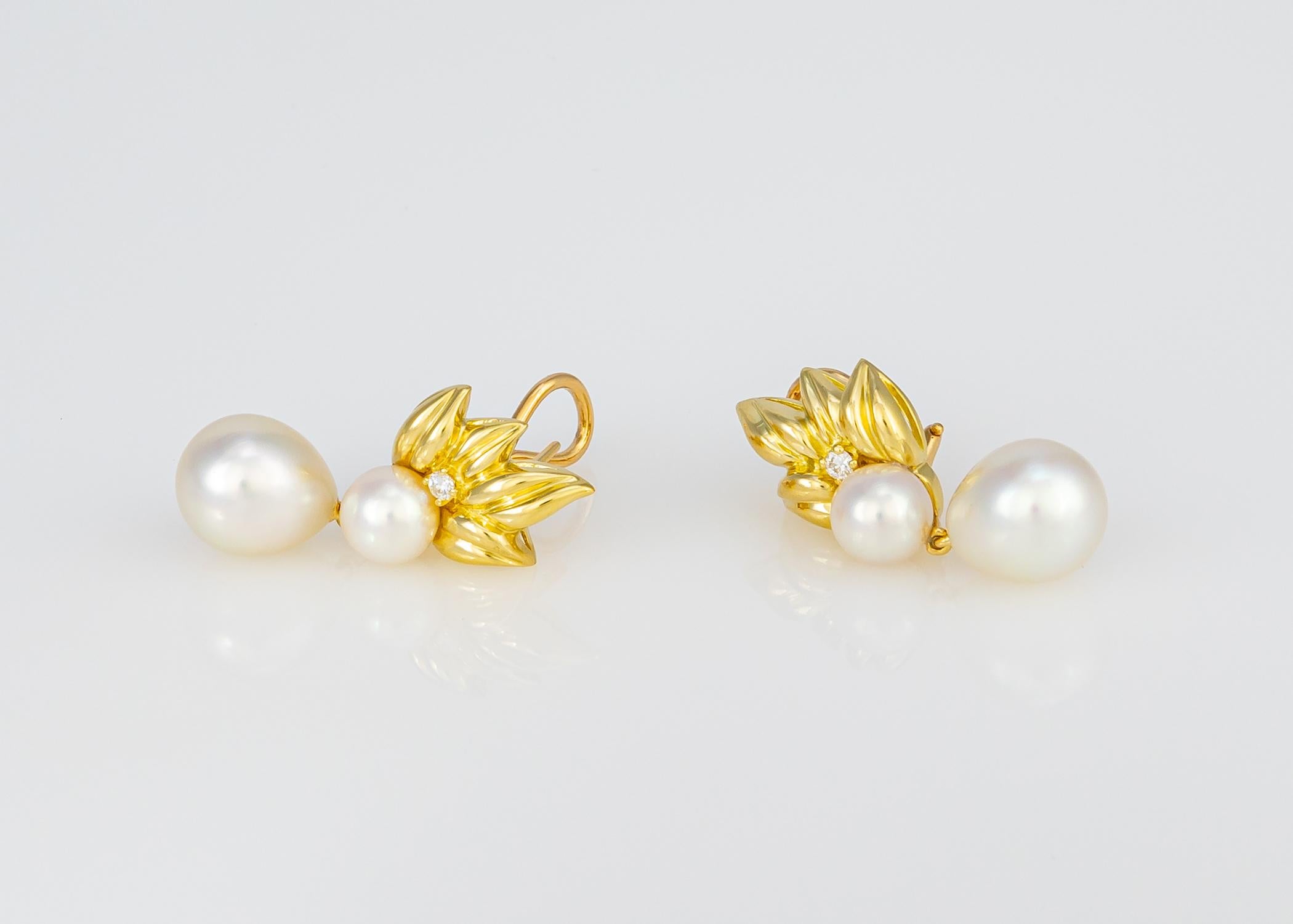 Tiffany & Co. created this classic pearl and diamond drop earring with all their iconic style and quality. A beautiful matched pair of south sea pearls 12.0 x 10.4 mm are suspended from leaf pattern 18k yellow gold tops and accented with two