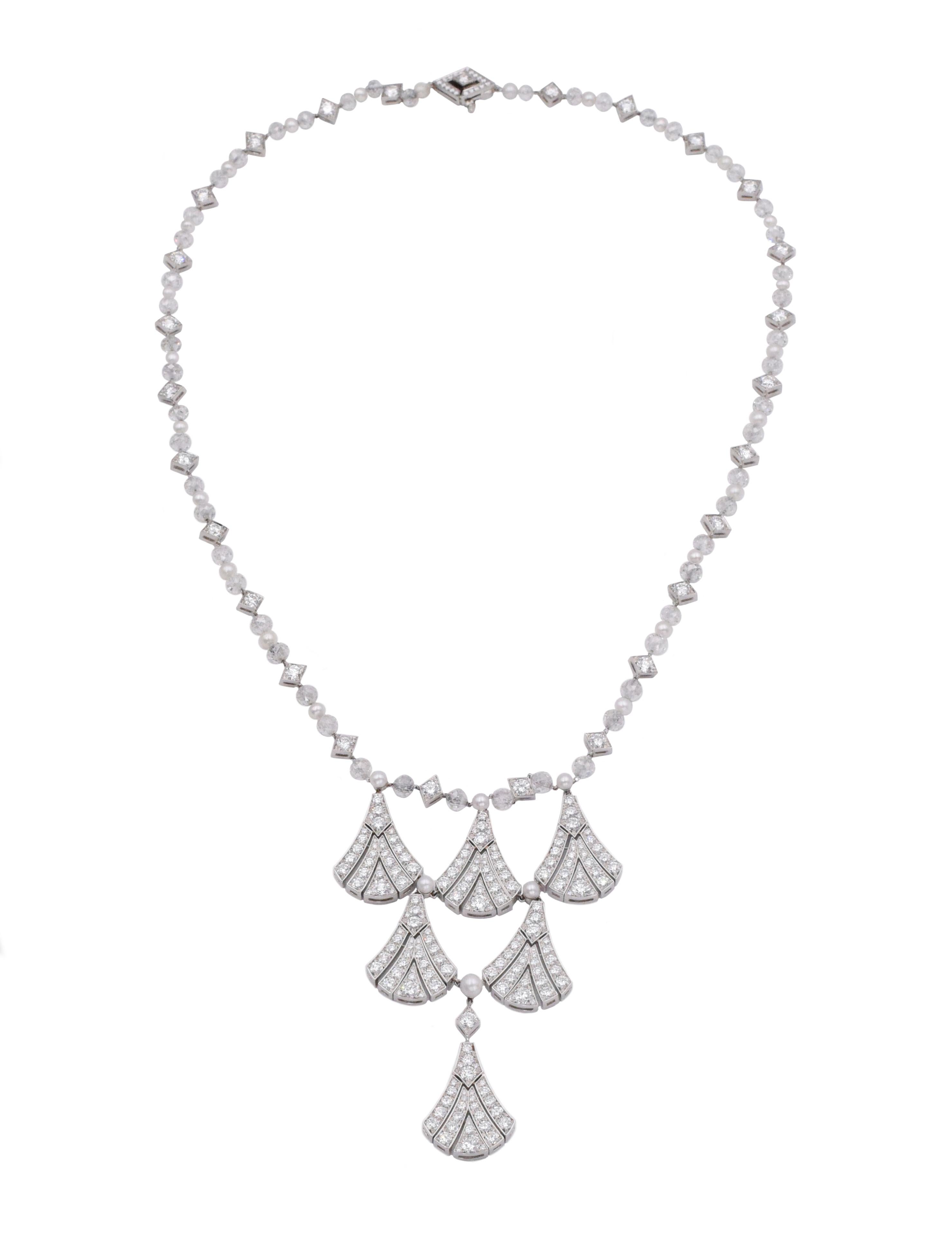 Tiffany & Co.  Diamond and cultured pearl necklace. Suspending six cascading fan motifs set with round diamonds, weigh a total of 11.59 carats, are near colorless & VS clarity. On a chain composed of faceted diamond beads alternating with lozenge
