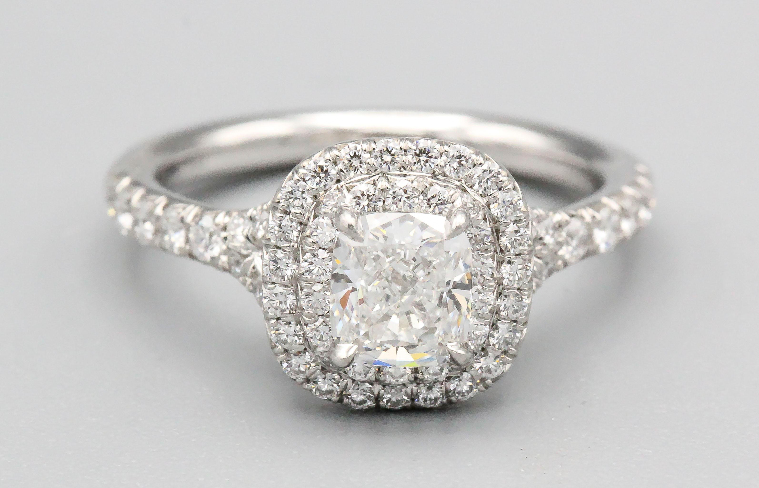Elegant diamond and platinum engagement ring by Tiffany & Co. It features high grade round brilliant cut diamonds throughout with the central stone being 0.56ct, F color, VVS2 clarity. Ring size 5.5.

Hallmarks: Tiffany & Co., PT 950, 0.56ct,
