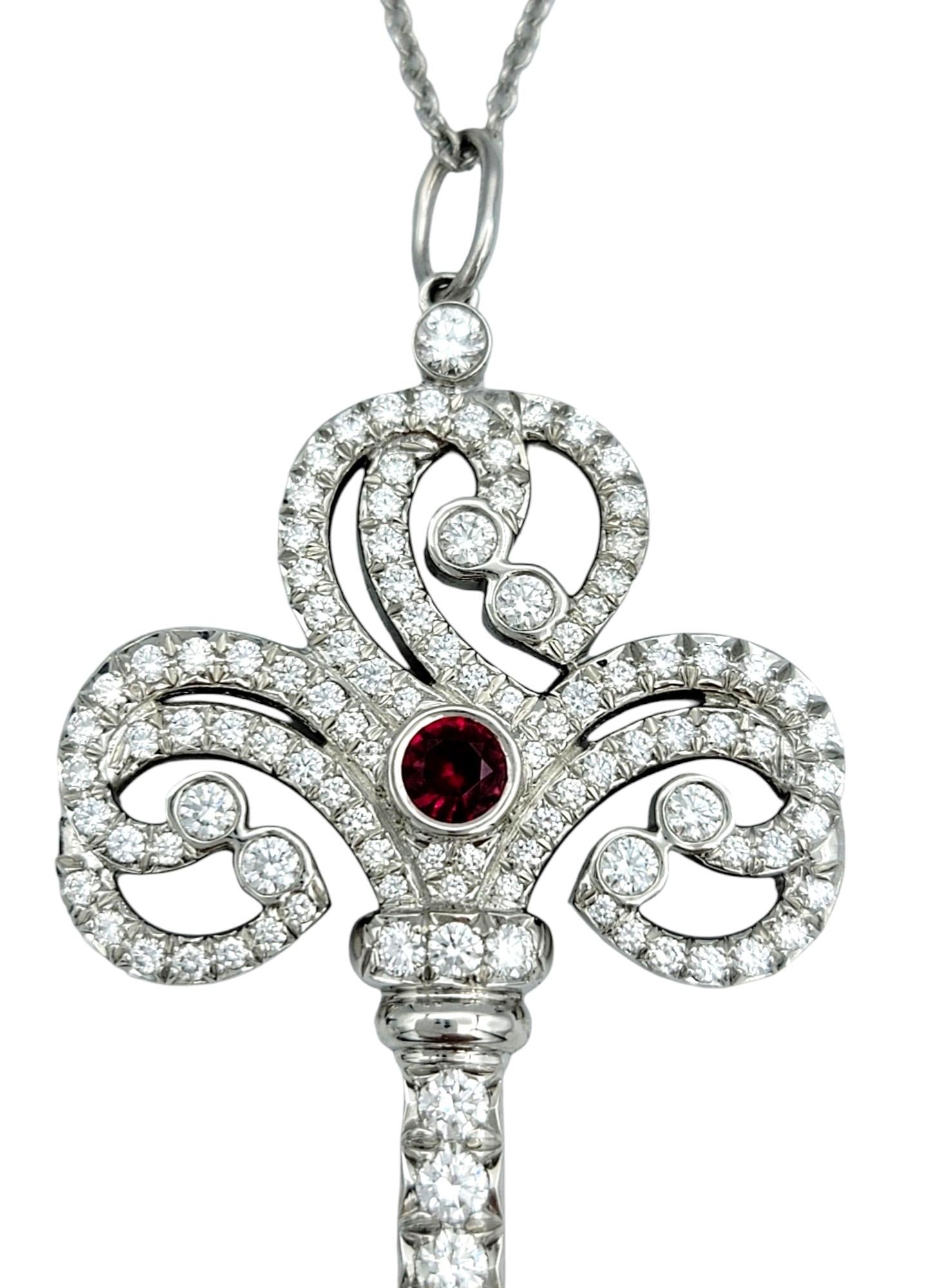 This stunning Tiffany & Co. diamond and ruby key pendant is an elegant work of art. Made from lustrous platinum, the key pendant exudes a sense of luxury. At the heart of the key is a gorgeous bezel set ruby surrounded by dazzling diamonds,