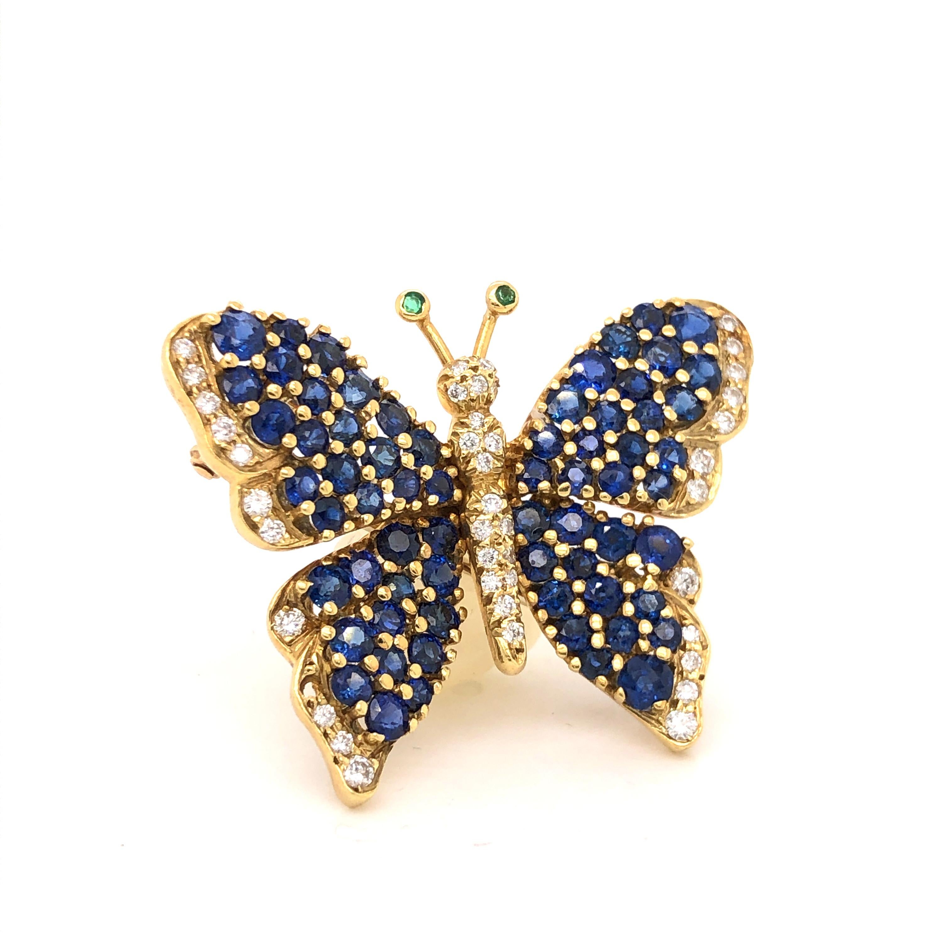 Amazing brooch from famed designer Tiffany & Co brooch is crafted in 18k yellow gold. This brilliant Butterfly design pops with color and is a true masterpiece. The brooch is set with sixty six natural Blue Sapphire across the wings all showing a