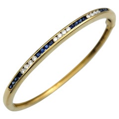 Tiffany & Co. Bracelet jonc articulé en or jaune 18 carats avec diamants et saphirs
