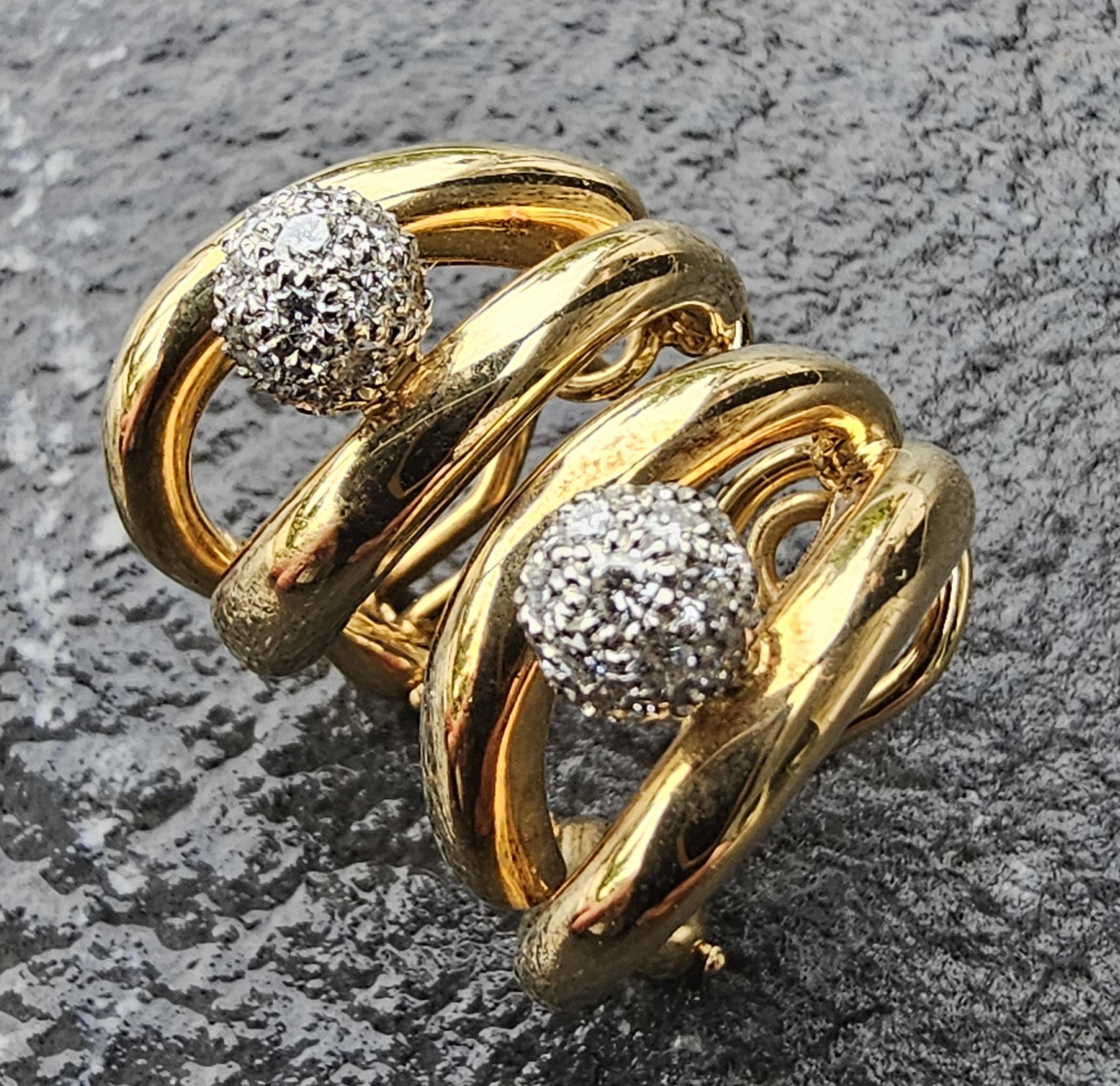 Realza tu conjunto con estos exquisitos pendientes de aro Tiffany & Co. Elaboradas en lujoso oro amarillo de 18 quilates y platino, presentan un cautivador diseño con una bola central de diamantes blancos. La intrincada disposición de los diamantes