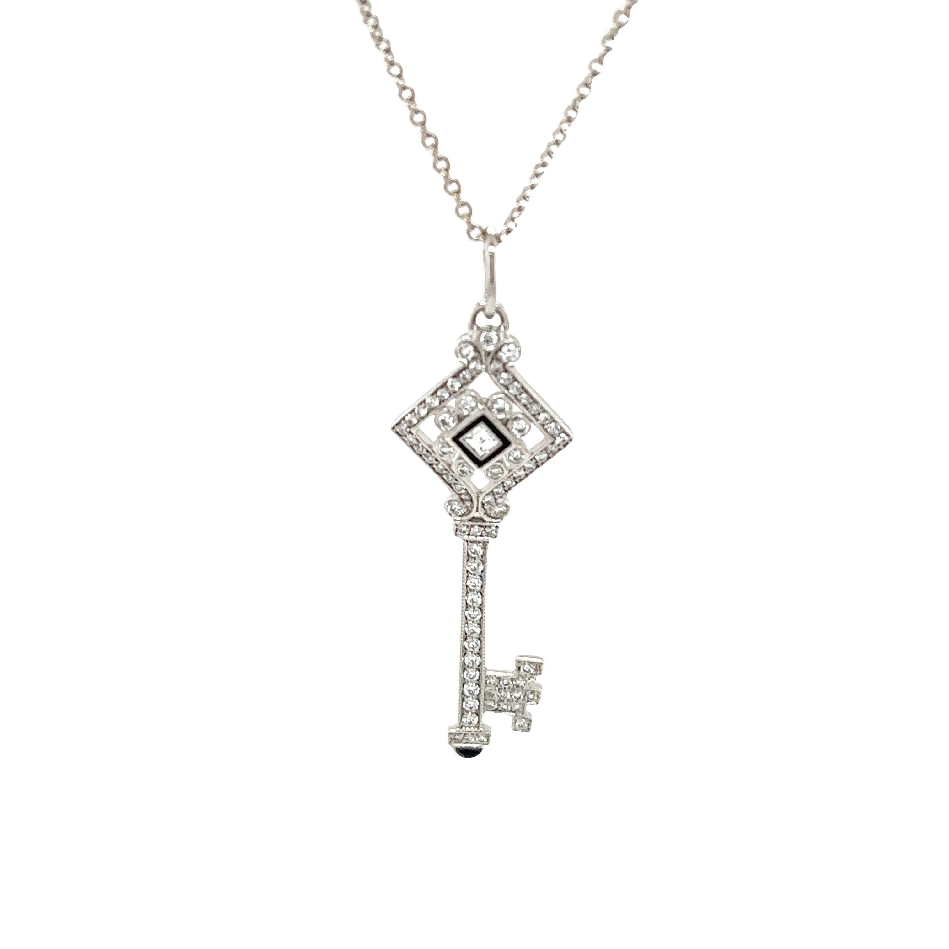 Elevate your style with this exquisite diamond black enamel 18ct white gold key pendant.
Crafted with precision and elegance, this pendant features a stunning design adorned with shimmering diamonds, with a total weight of 0.35ct F/VS brilliant cut