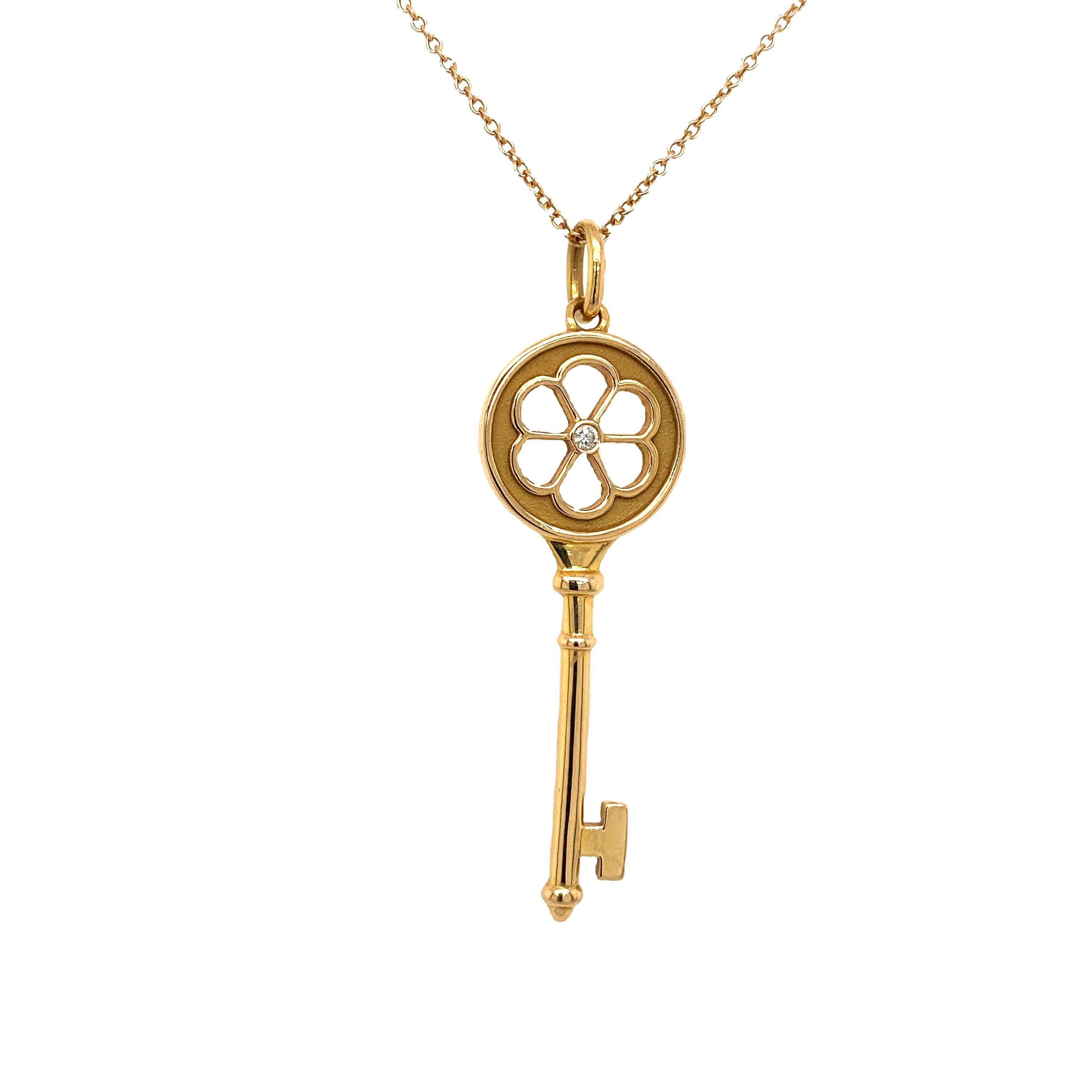 This beautiful diamond blossom flower key pendant is suspended from a 16
