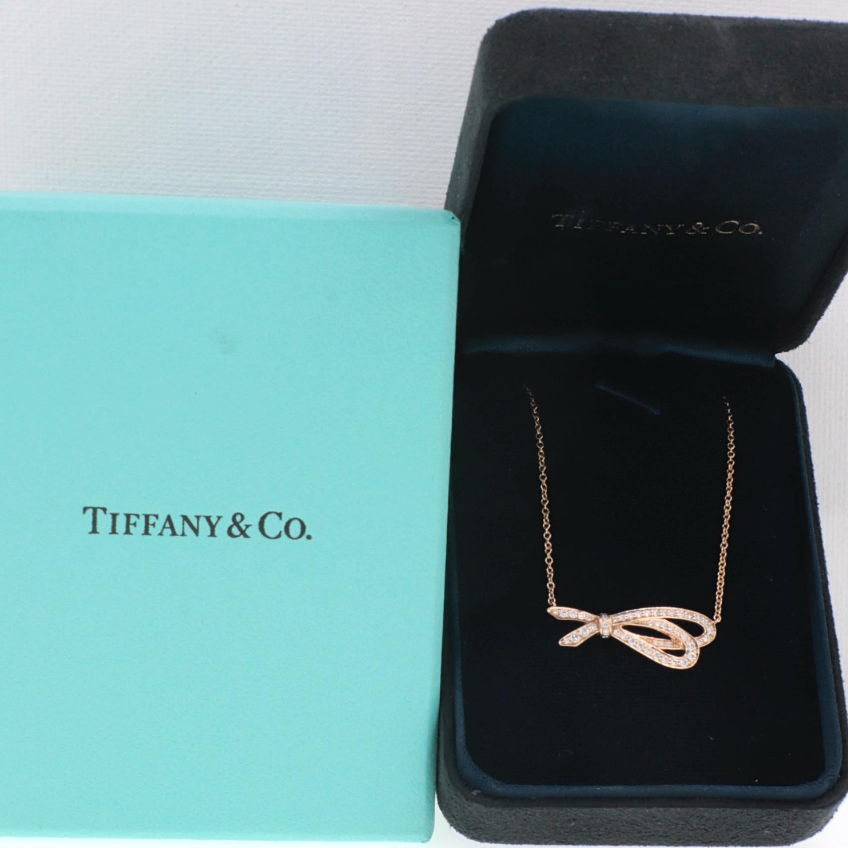 Tiffany & Co. Necklace
Style:  Diamond Bow Pendant Necklace 
Gold:  18K Rose Gold
TCW:  0.37 Carat Total
Diamond:  44 Round Brilliant Cut Diamonds
Color & Clarity:  G Color, VS1 Clarity
Hallmark:  Tiffany&Co. AU750
Includes:  Tiffany Pendant Box,