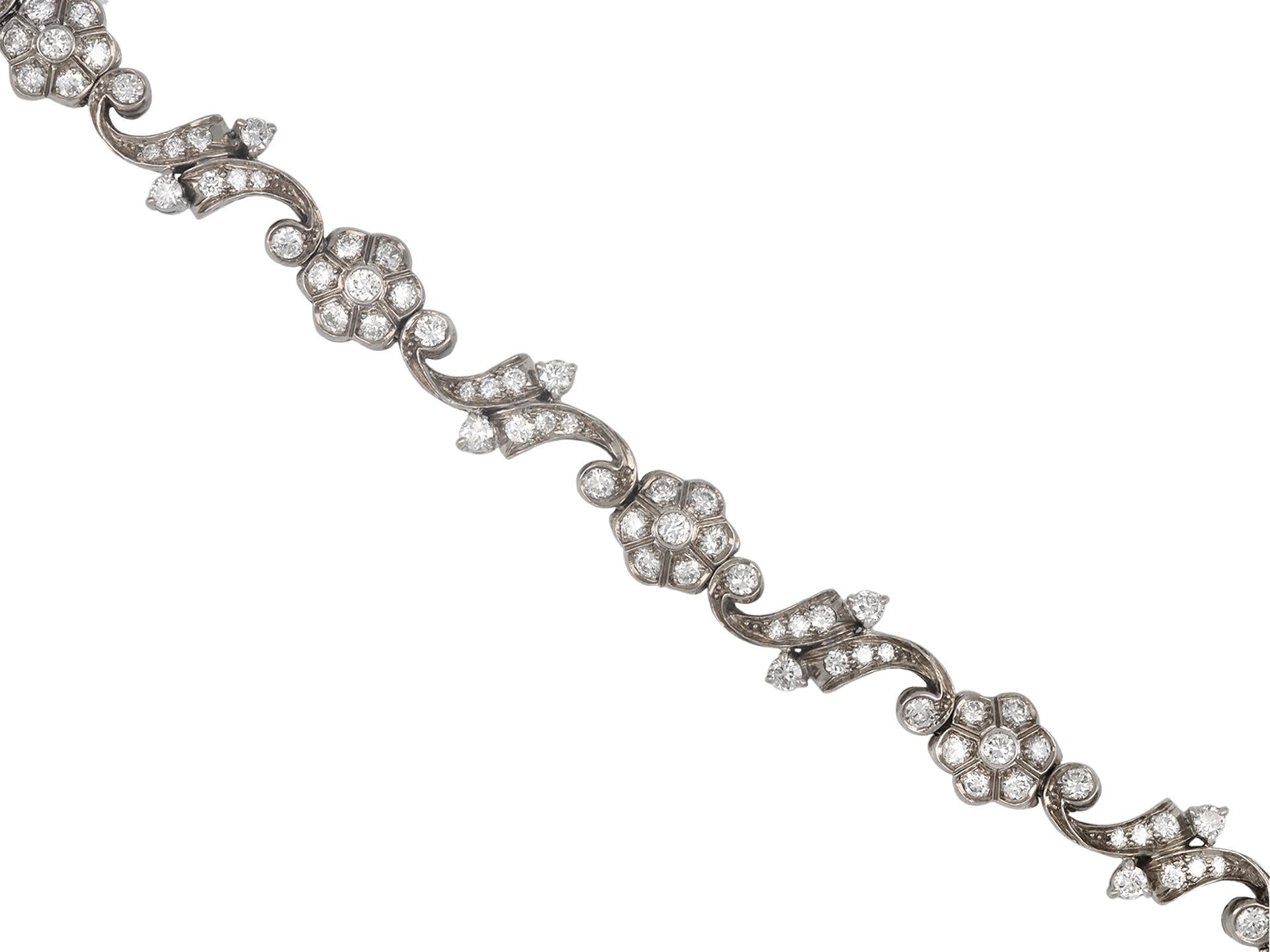 Tiffany & Co. diamond bracelet. Set with one hundred and two round old cut diamonds in open back grain, claw and rubover settings with a combined approximate weight of 4.00 carats, to an articulated bracelet consisting of elegant floral motif links