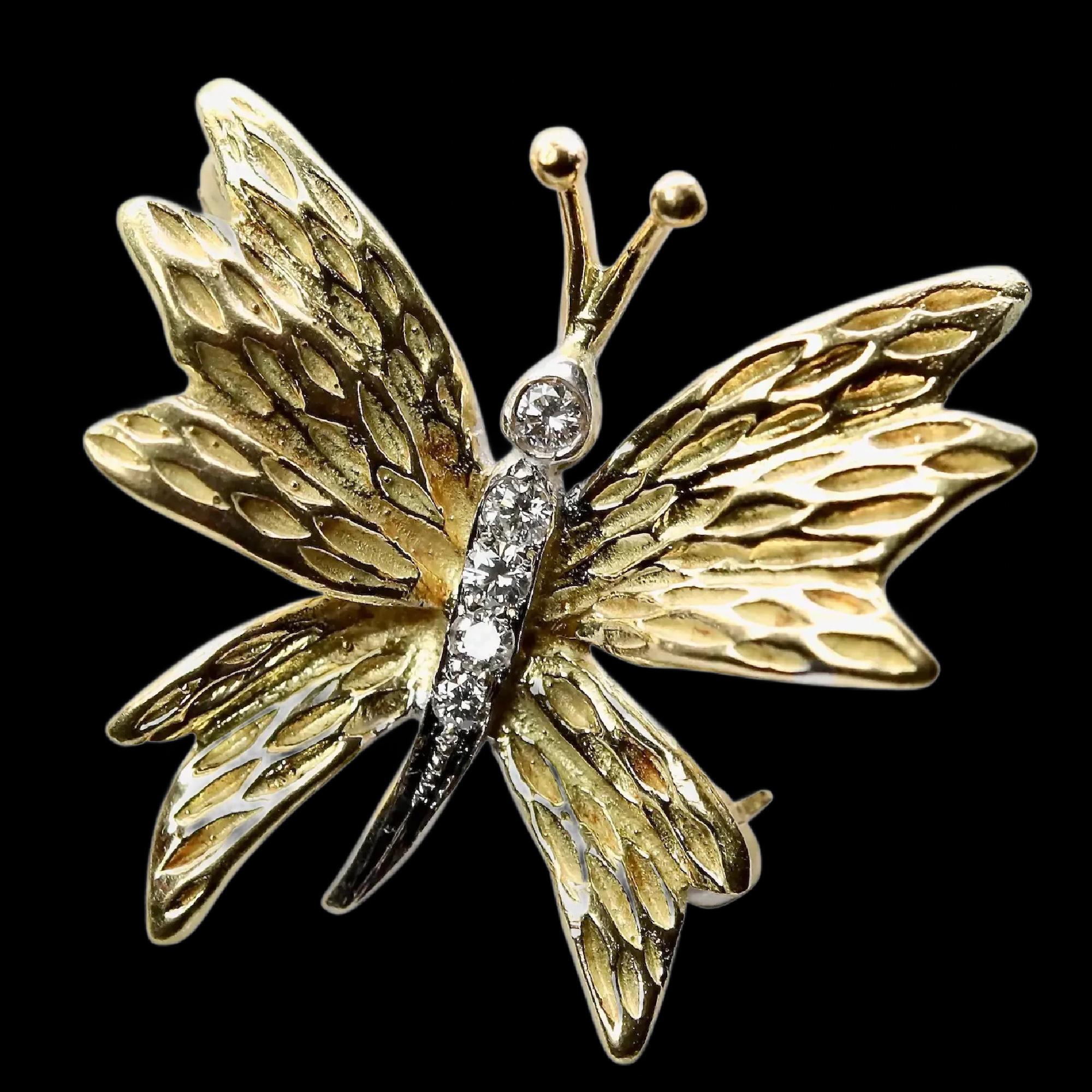 A vintage Tiffany & Company diamond butterfly brooch in 18 karat yellow gold. Accented by five diamonds weighing 0.10 carats and grading as F color, VVS clarity.

In excellent condition, this brooch is hallmarked as and tests as 18 karat gold.
