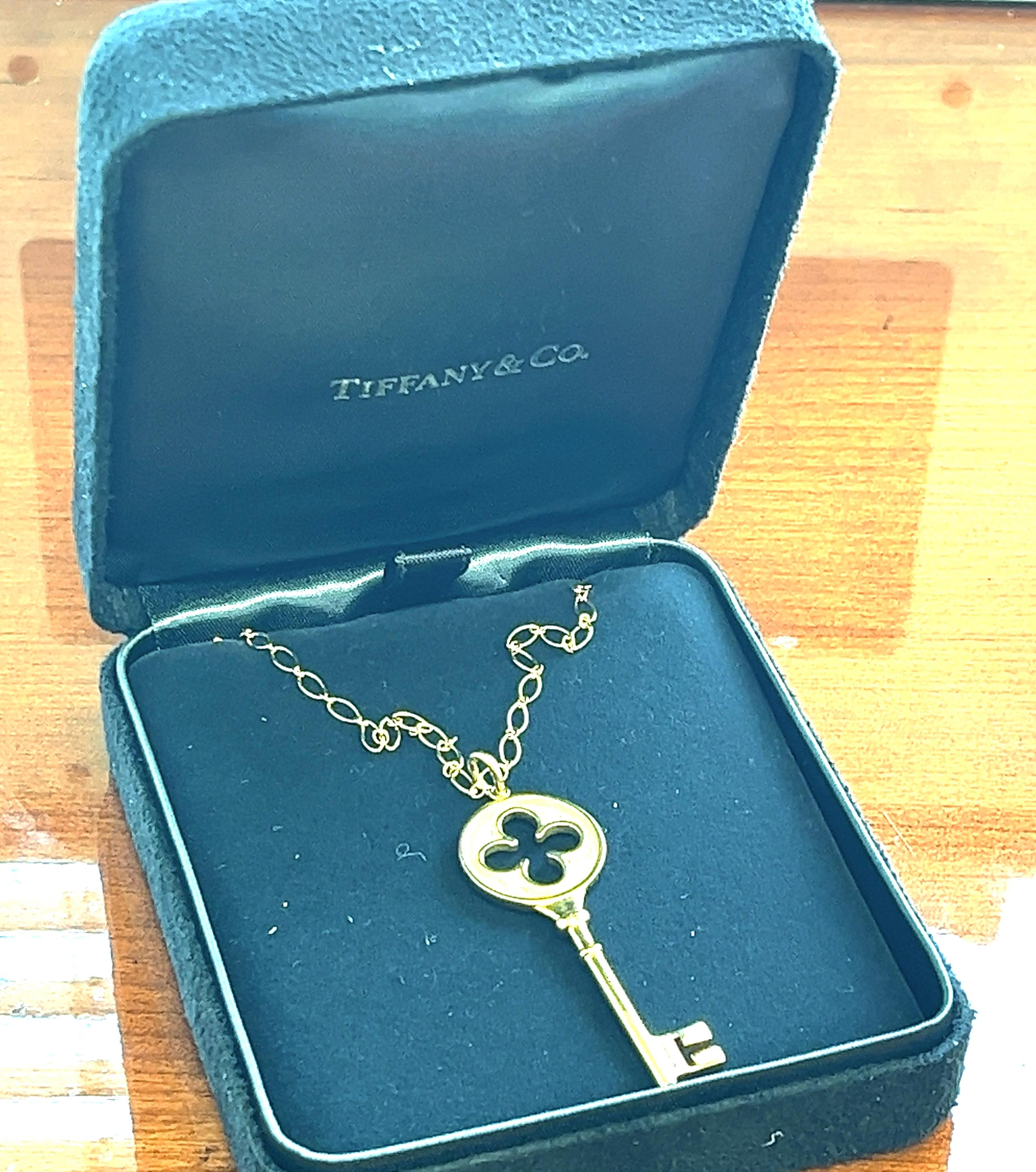 Offered here is a Tiffany & Co. Clover Leaf Key Pendant in 18kt yellow gold with diamonds.

Brilliant beacons of optimism and hope, Tiffany keys are radiant symbols of a bright future.
A timeless elegant design, this lucky charm pendant shines with