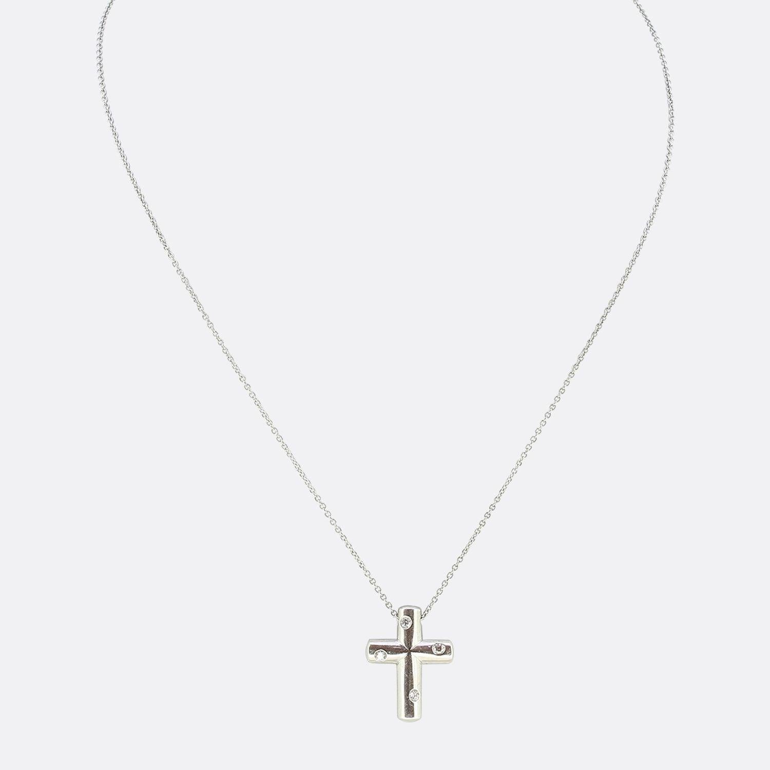 This is a platinum, diamond pendant from the luxury jewellery designer Tiffany & Co. The necklace is in a cross motif crafted in platinum and set with four round brilliant cut diamonds. The pendant has been suspended on a platinum chain.