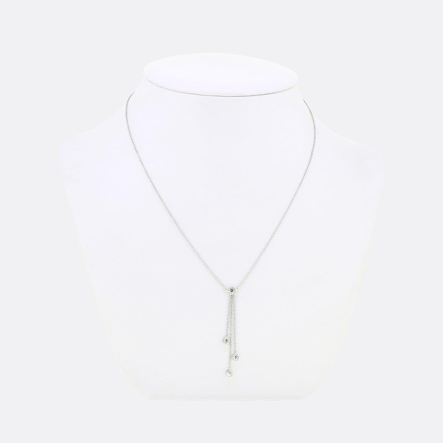 Here we have a beautiful platinum diamond necklace from the world renowned luxury jewellery designer, Tiffany & Co. A 0.20ct round brilliant cut diamond sits at the centre of the piece with a trio of belcher chains suspending three slightly smaller
