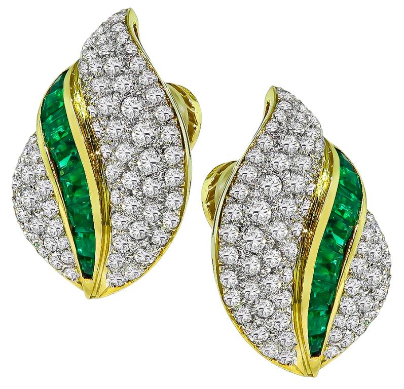 This elegant pair of 18k yellow and white gold earrings by Tiffany & Co. feature sparkling round cut diamonds that weigh approximately 5.50ct. graded E-F color with VS clarity. The diamonds are accentuated by lovely Colombian emeralds that weigh