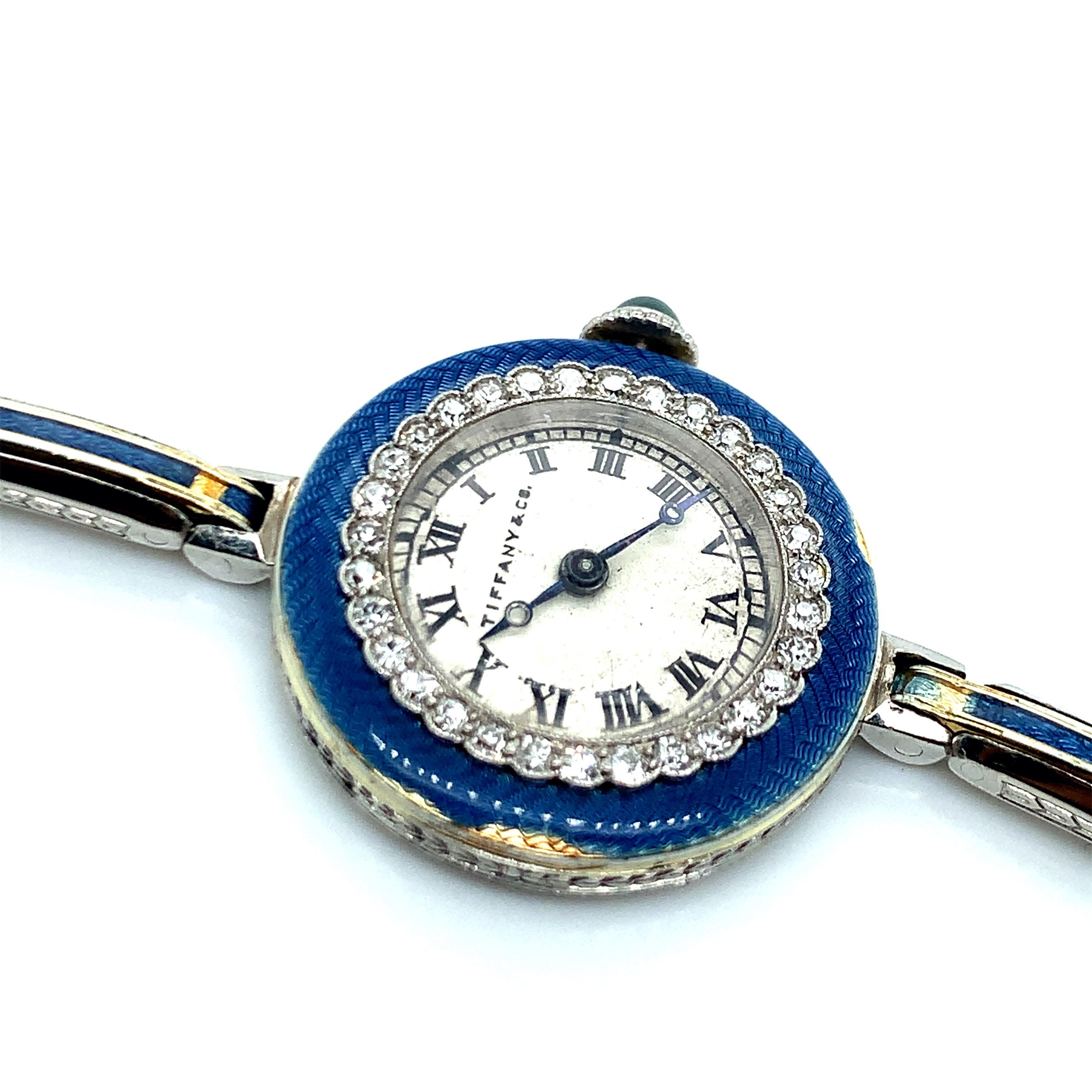 Tiffany & Co. platinum and gold diamond enamel expandable wristwatch. Meylan 17 jewel movement, 32 diamonds weighing approximately 1 carat. Inner circumference: 6.25 inches. Can expand to 7.25 inches. Case measurements: width and length are both 2.3