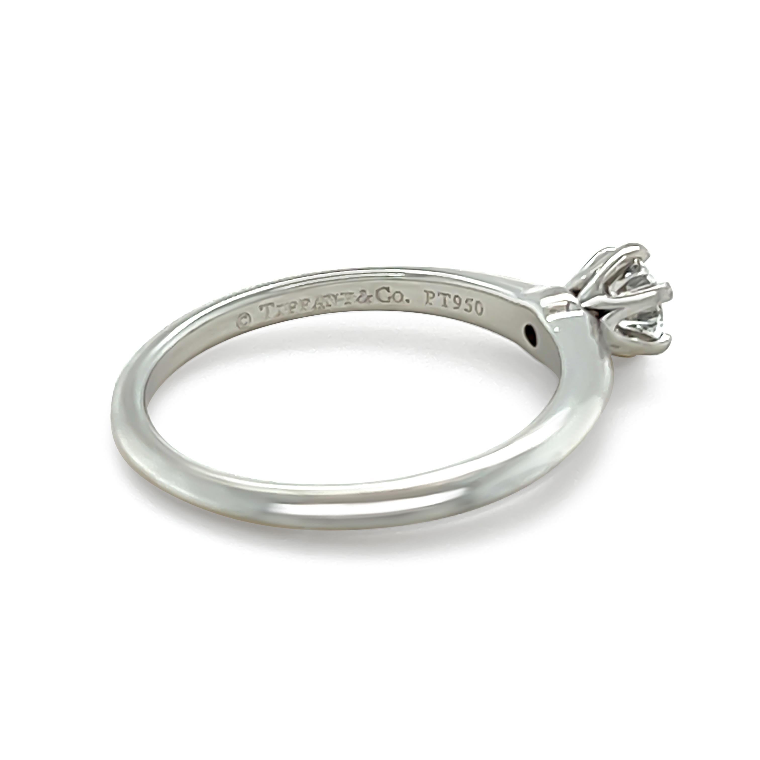 A Tiffany & Co Solitaire Round Brilliant Cut Diamond Ring, six claw set in platinum on a 1.8mm knife edge band.

Tiffany & Co grading report 26057892/K10010137, crown laser inscribed:-Weight: 0.32ct Colour: F, Clarity: VVS1

Metal: Platinum