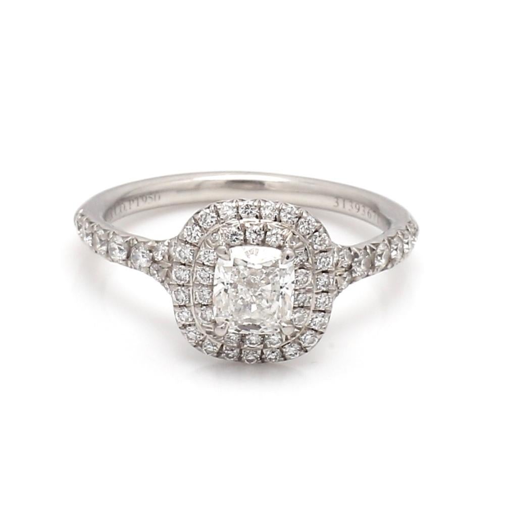 Tiffany & Co., platinum (marked PT950), diamond ring and wedding band set. Ring's center stone is one (1) cushion cut diamond weighing 0.52ct. Double halo and shank of ring are set with sixty-three (63) round brilliant cut diamonds weighing