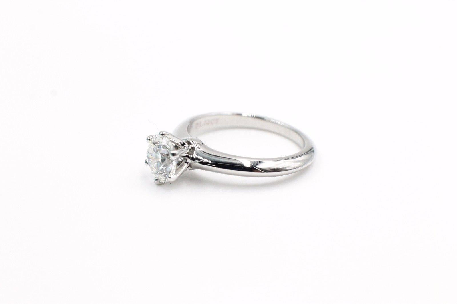 Tiffany & Co 
Classic Six Prong Solitaire Engagement Ring in Platinum.... 
Round Brilliant Cut Diamond is a 1.02 CTS H color, VS1 Clarity.  
Size 6 - sizable.  
Diamond has crown inscription 