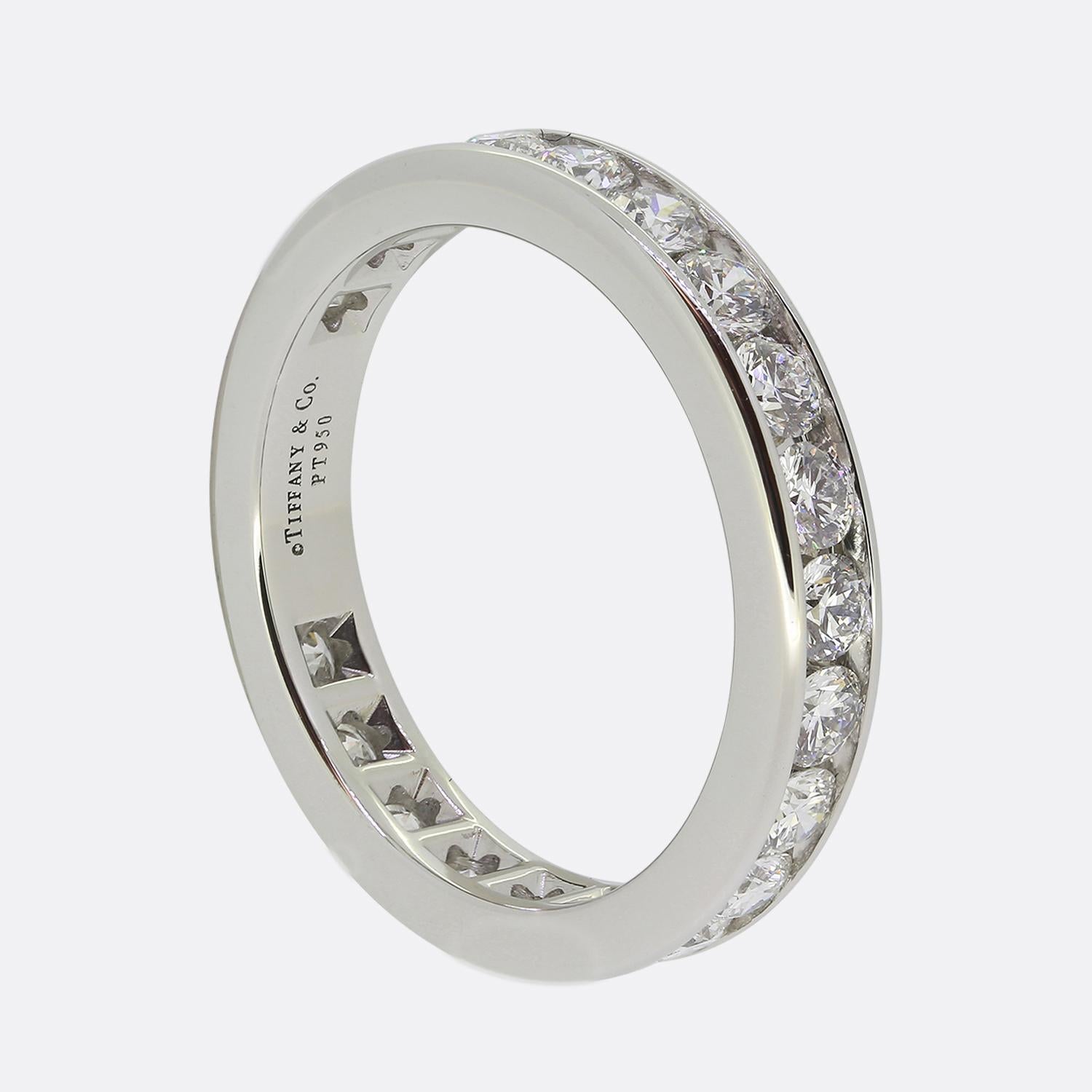 Here we a classically styled diamond full-eternity ring from the world renowned jewellery designer, Tiffany & Co. This platinum piece features 23 round brilliant cut diamonds; all of which have been channel set in a single line formation to wrap