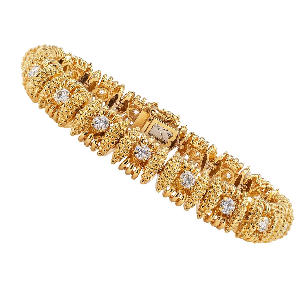 Tiffany & Co diamond and gold bracelet circa 1970.  Designed as a series of rectangular links featuring open work and granulated textures, each centering upon a round brilliant-cut diamond, the eighteen diamonds totaling approximately 2.25 carats,