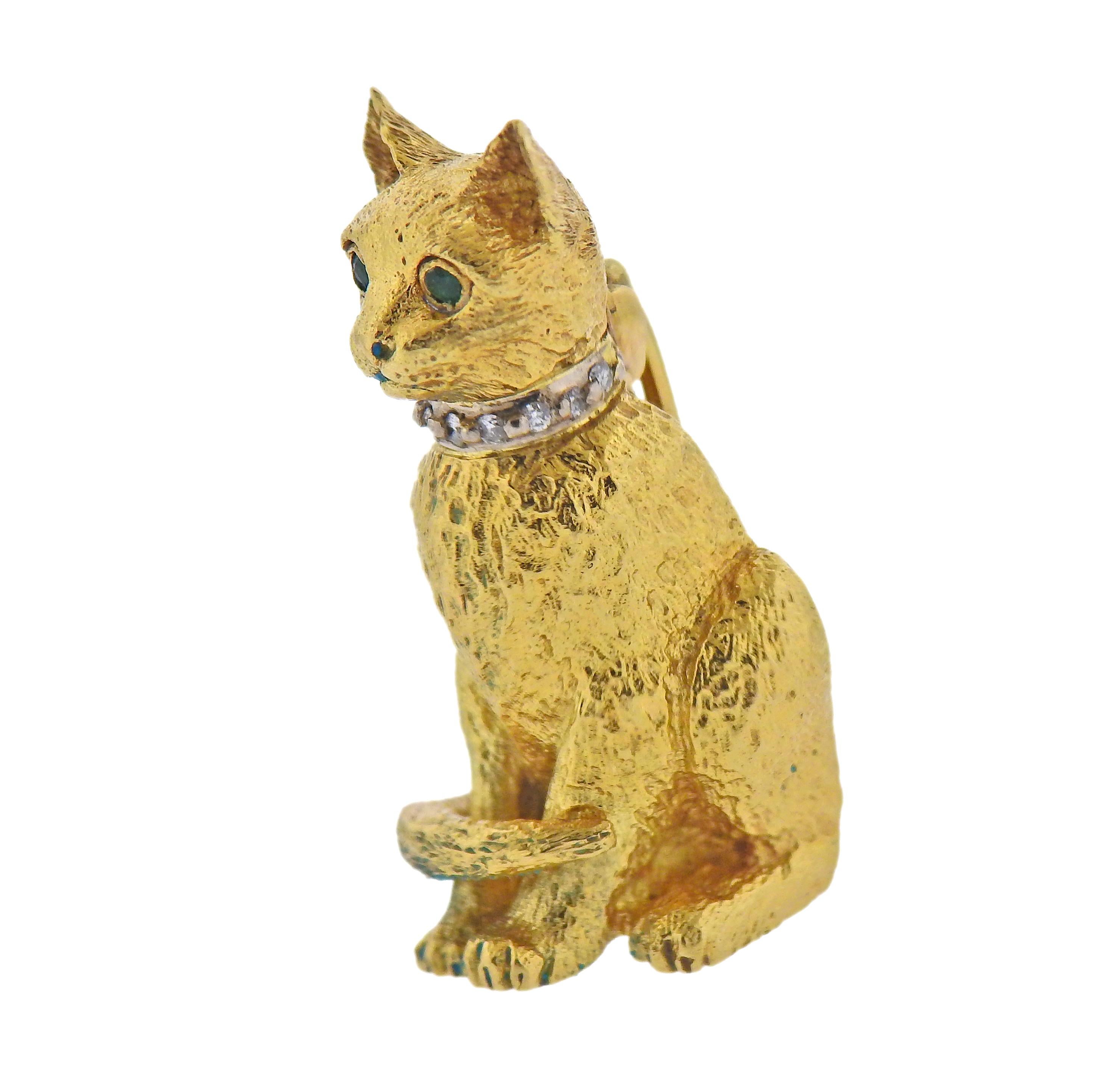 Tiffany & Co 18k gold cat brooch, with approx. 0.06cts in G/VS diamonds and emerald eyes. Brooch is 25mm x 13mm. Weight - 7.3 grams. Marked: Tiffany & Co, 750, 1991.