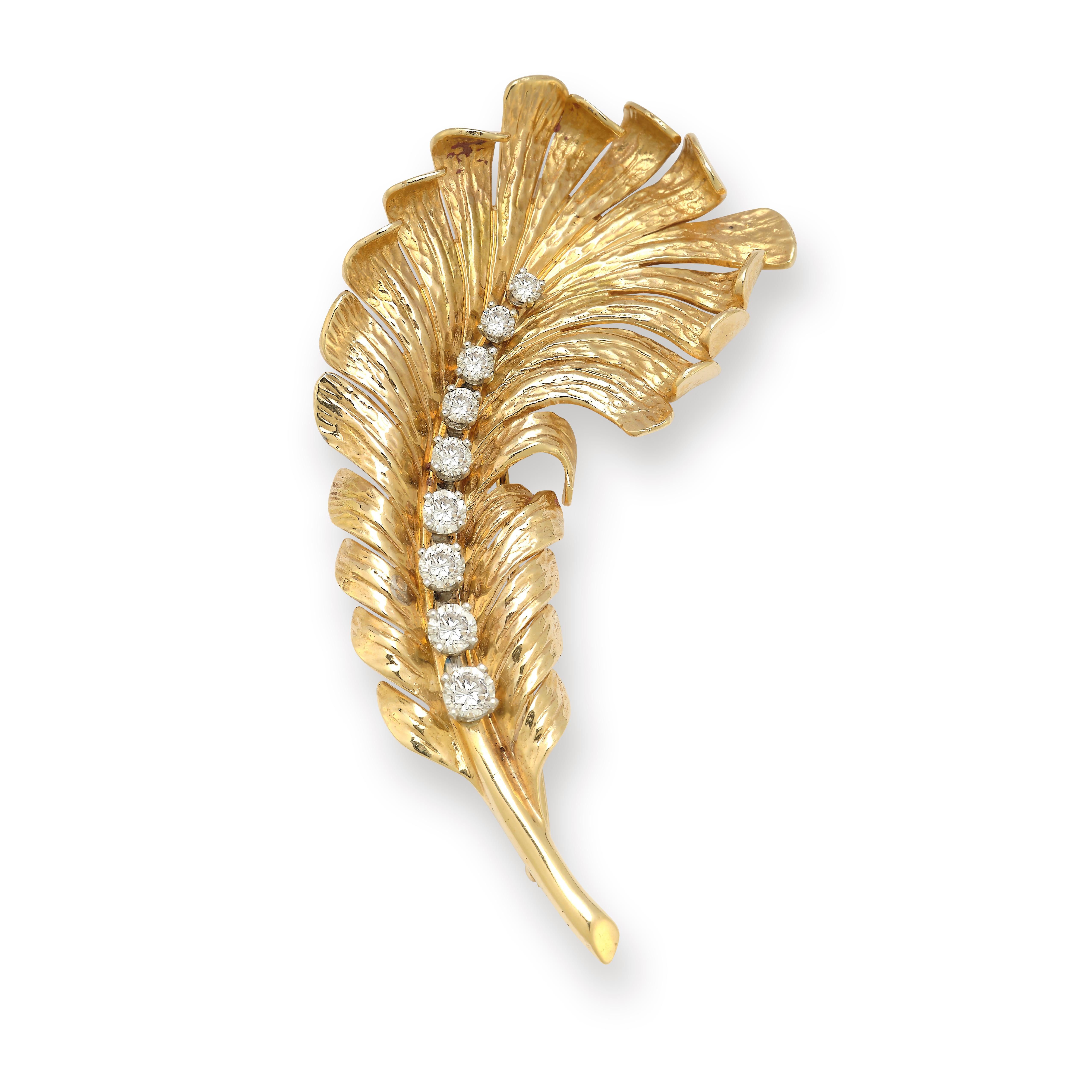  Tiffany & Co Diamond & Gold Floral motif Brooch

9 graduated round cut diamonds approximately set in 14k yellow gold.

Measurements: 2.75