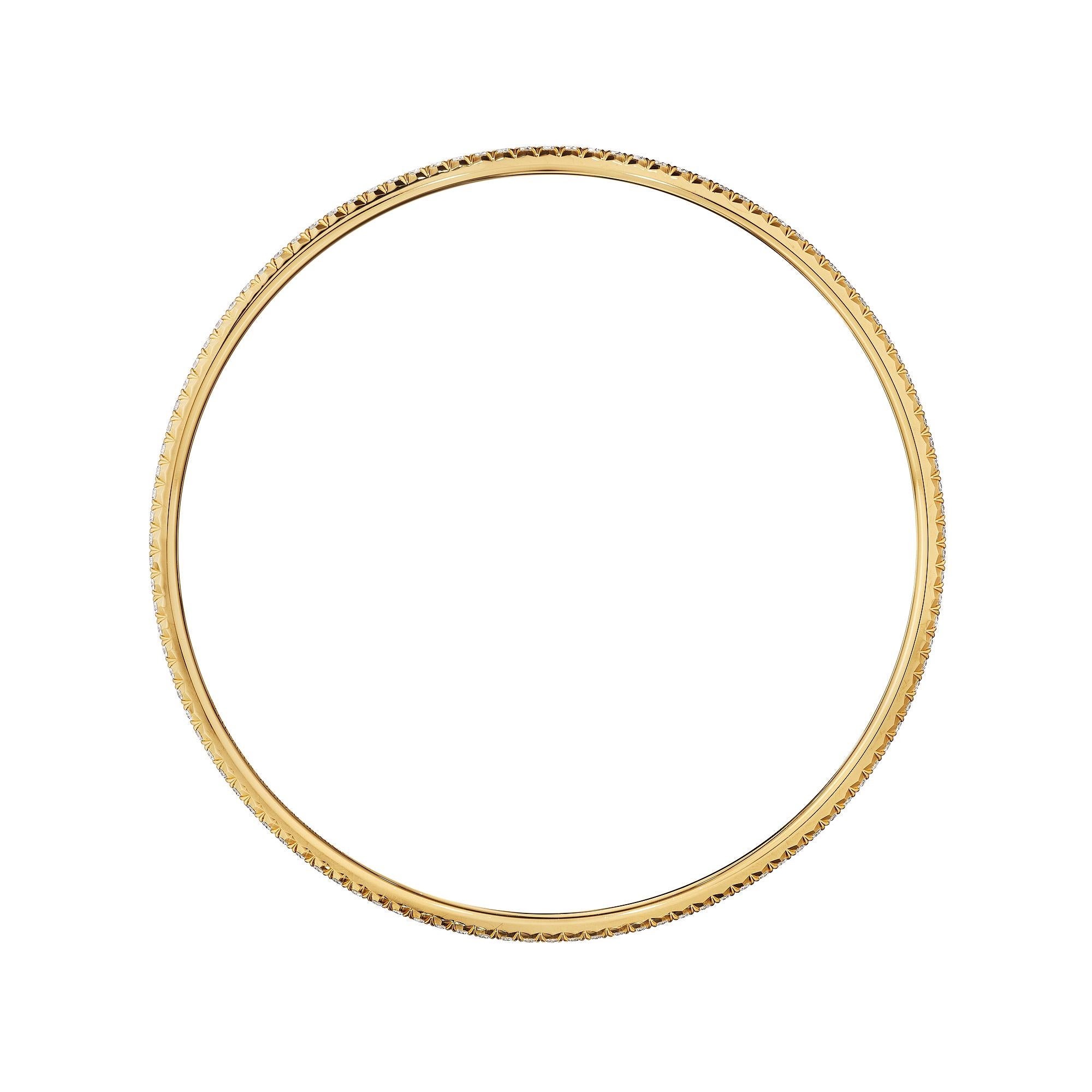 With a delicately ethereal spirit, this Tiffany & Co. diamond and 18 karat yellow gold modernist bangle bracelet is femininity at its best.  Signed Tiffany & Co. Belgium.  Circa 2020.  Size medium.  2 1/2