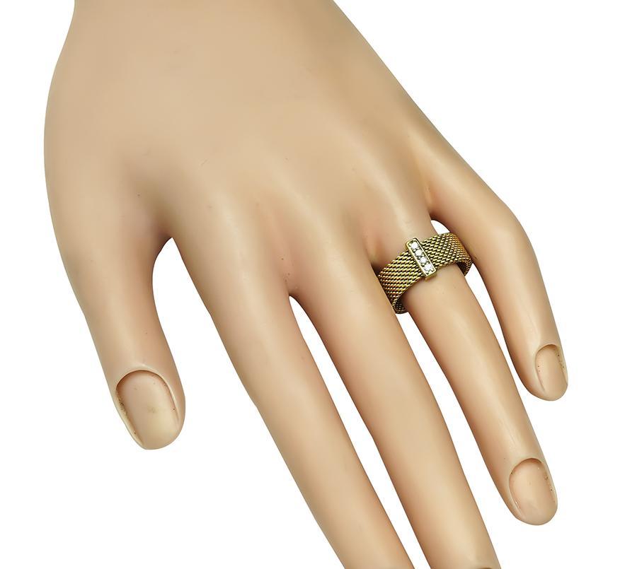 This is a charming 18k yellow gold ring by Tiffany & Co. The ring is set with sparkling round cut diamond accents. The ring measures 7mm in width and weighs 6.2 grams. The ring is signed T&Co 750. The ring is size 6 3/4 but it can be resized.
