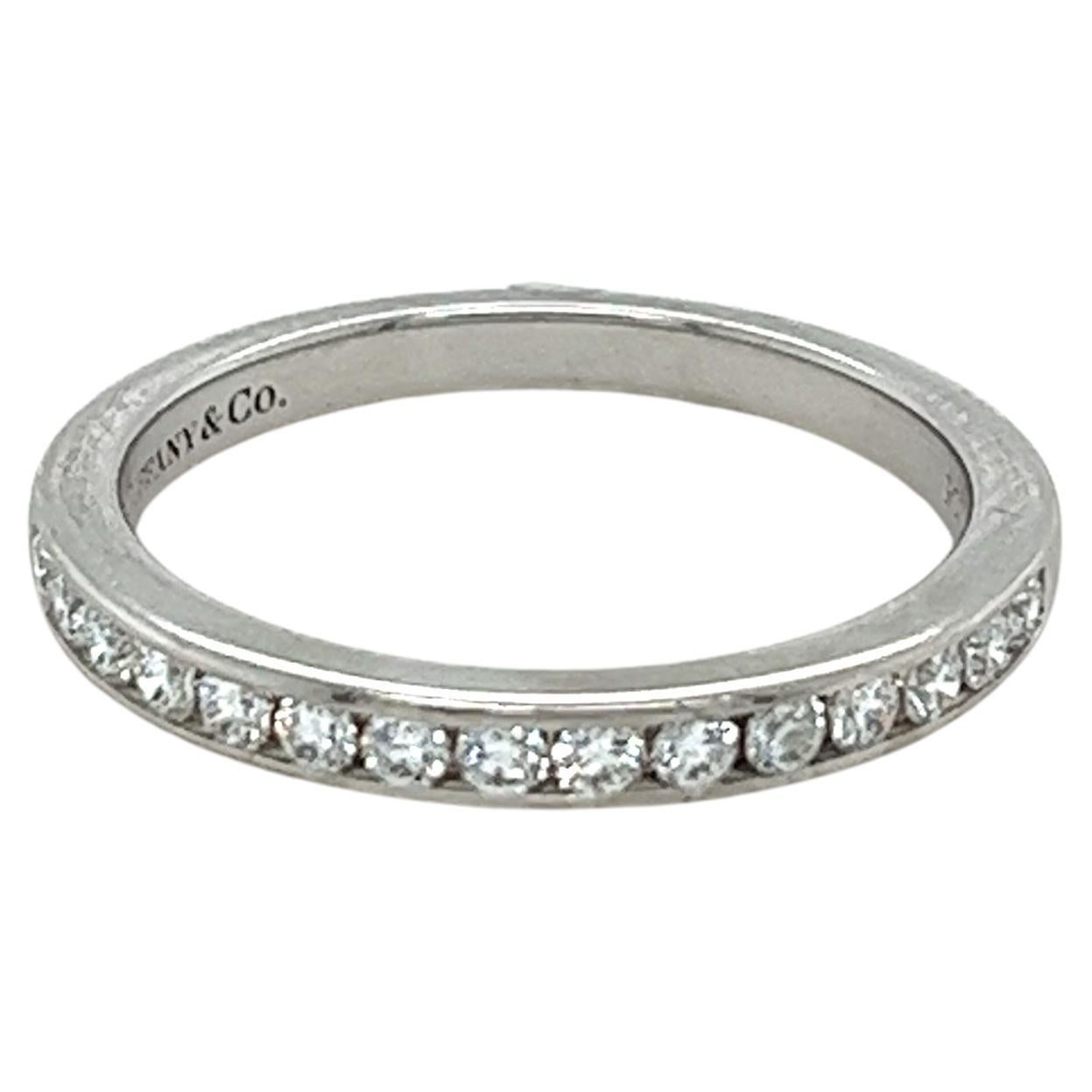 A Tiffany & Co Diamond Wedding Ring, with 15 round brilliant cut diamonds channel set in platinum on a 2.5mm band.

Diamonds 15 = 0.24ct (estimated)

Metal: Platinum PT950
Carat: 0.24ct
Colour: F
Clarity: VS
Cut: Round Brilliant
Weight: 3.77