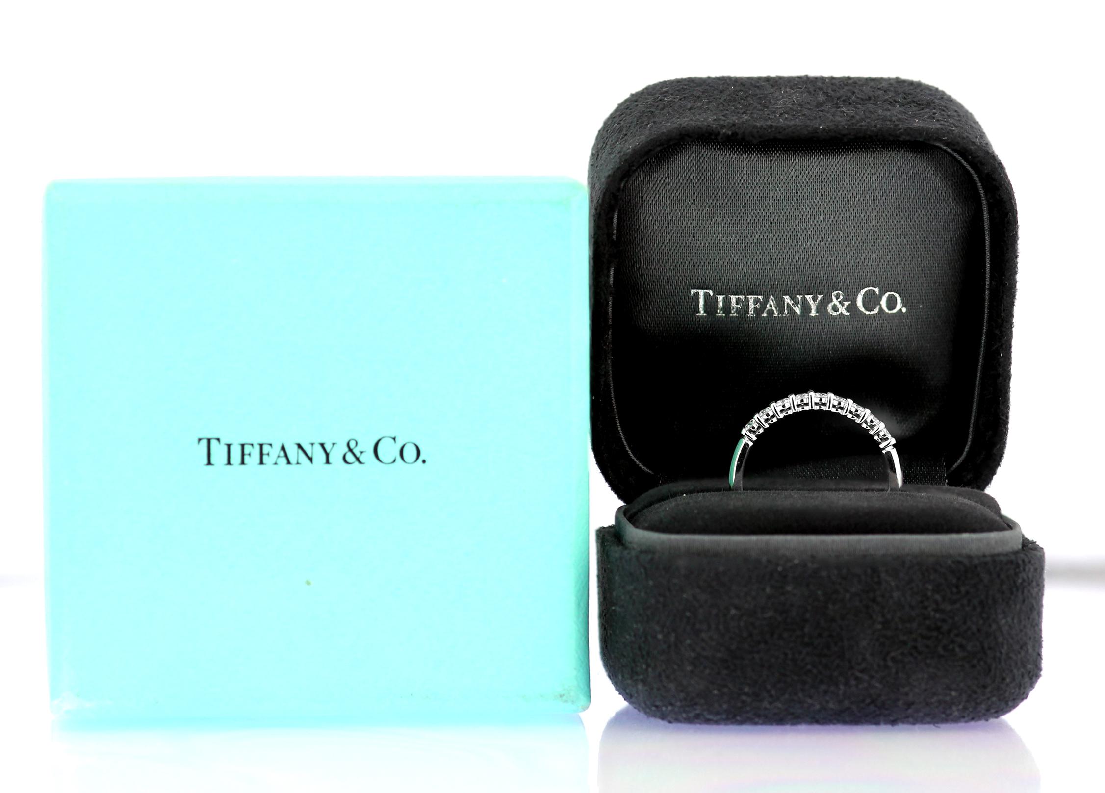 A diamond half eternity ring set in platinum by Tiffany, British Hallmarked London 2012, sponsor mark 