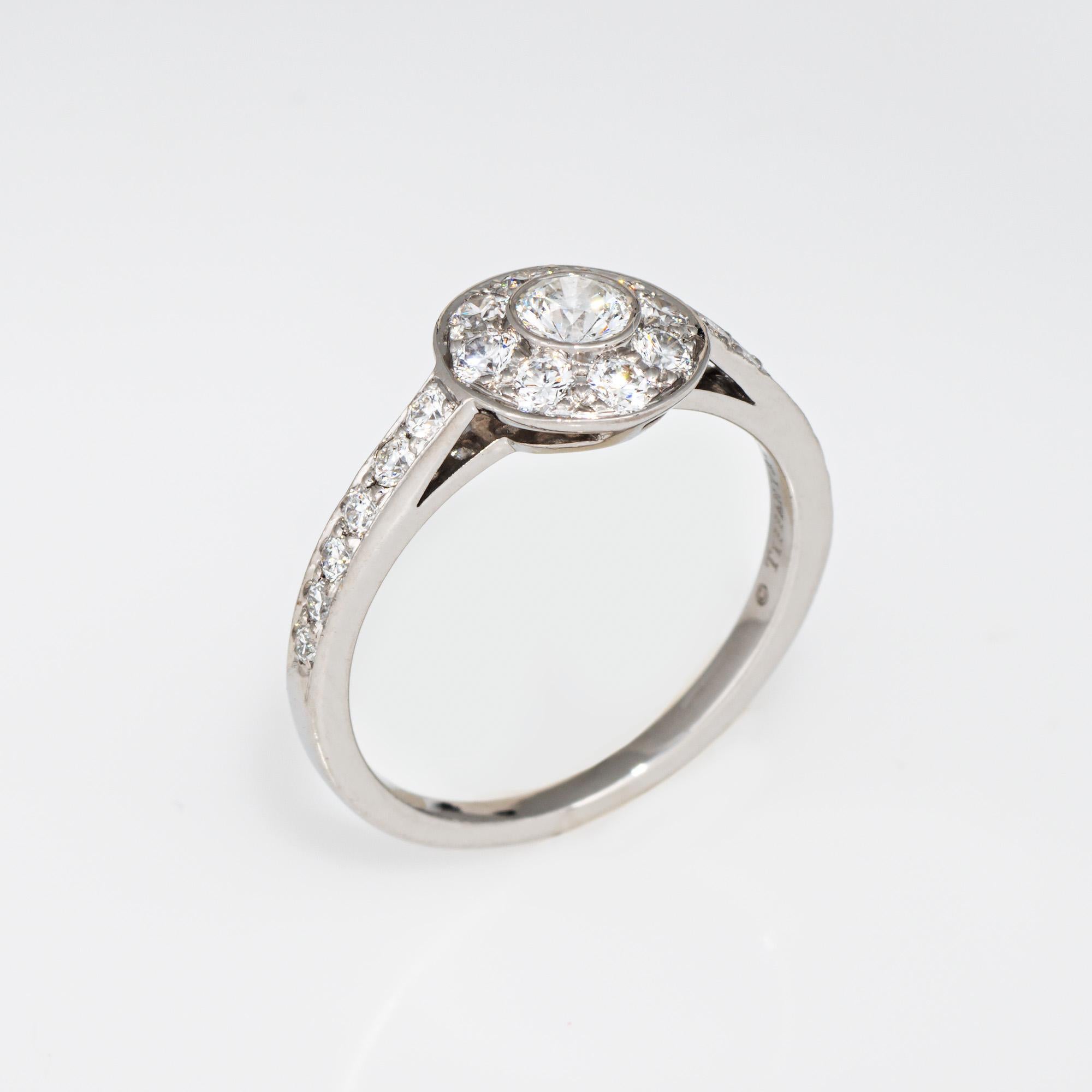 Pre-owned Tiffany & Co halo ring crafted in 950 platinum (circa 2000s).  

Center set round brilliant cut diamond is estimated at 0.20 carats. Accenting diamonds total an estimated 0.48 carats (estimated at F-G color and VS1-2 clarity). 

The