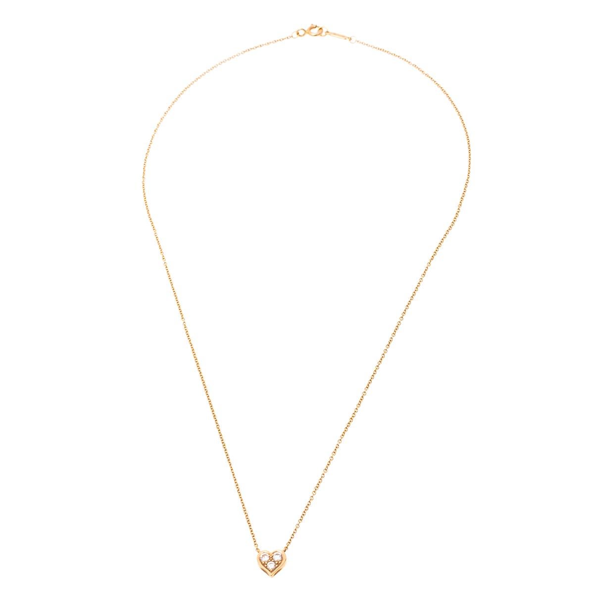 This lovely necklace by Tiffany & Co. will make a timeless addition to your collection. Crafted from precious 18k yellow gold, this gorgeous creation has a chain that holds a lovely heart pendant. The pendant is adorned with three shimmery diamonds.