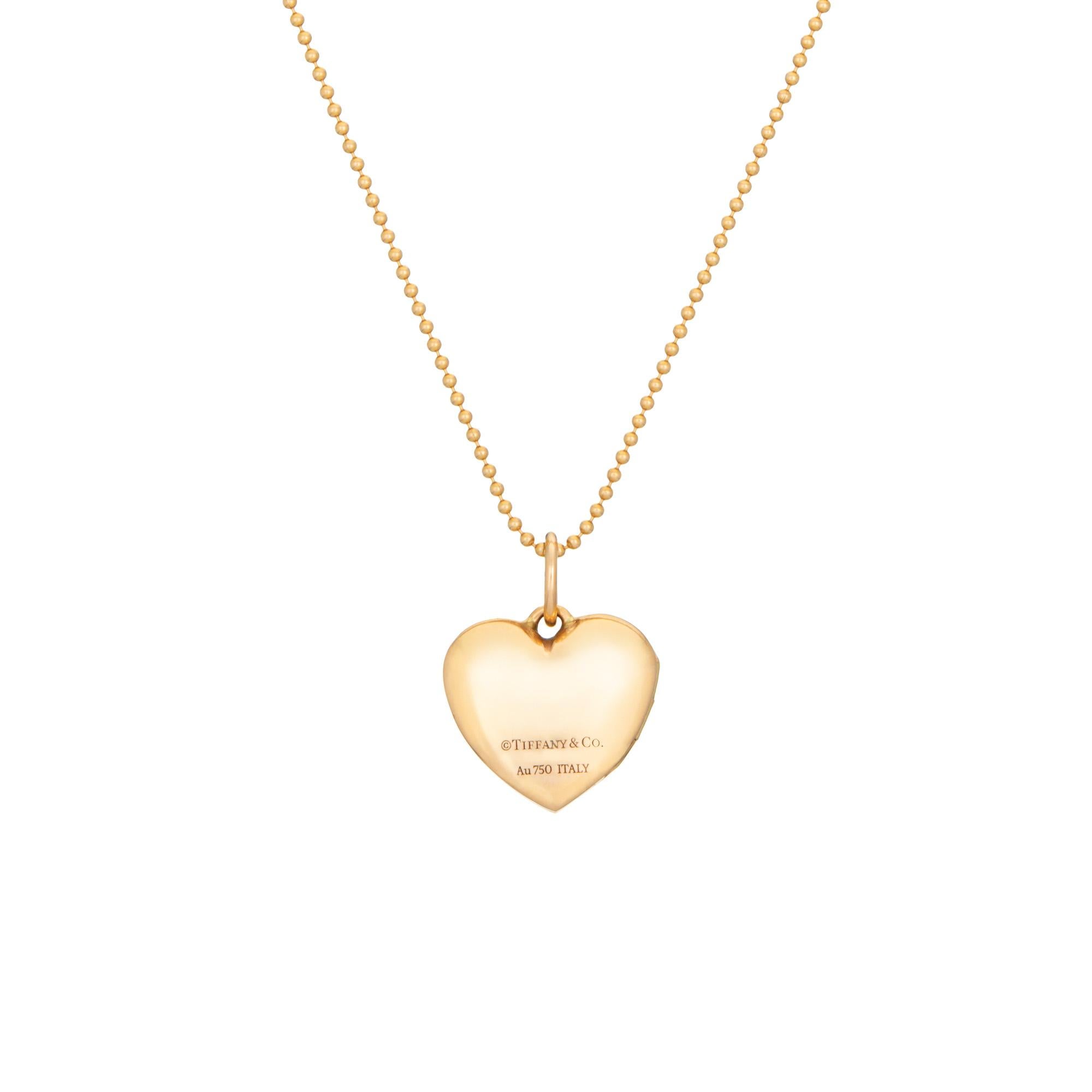 Stylish and finely detailed estate Tiffany & Co diamond heart locket & necklace, crafted in 18 karat rose gold (circa 2000s).  

Diamonds total an estimated 0.03 carats (estimated at G-H color and VS2 clarity). 

The charming heart locket opens to