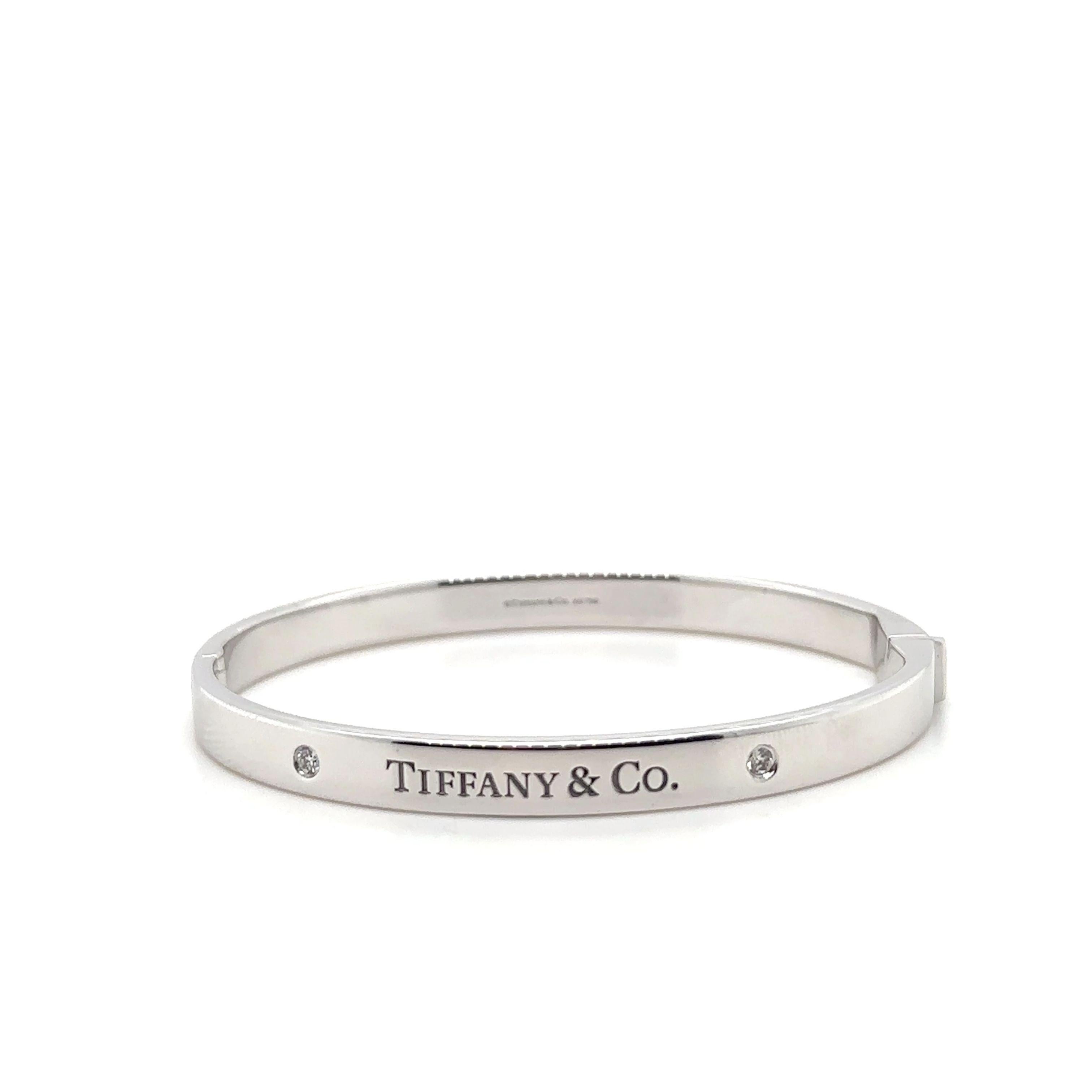  A Tiffany & Co. Diamond bangle, made of 18ct White Gold, and weighing 38.7 gm.

Stamped: Tiffany & Co. AU 750.

The bangle is set with 2 round, brilliant cut Diamonds, colour D-E and clarity VVS with a total weight of 0.10 ct.

Metal: 18ct White