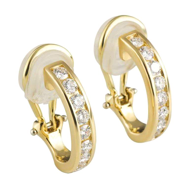 A beautiful pair of diamond set hoop earrings by Tiffany & Co. The hoops are channel set with 8 diamonds in each hoop and totals to approximately 0.96ct. The earrings feature post and clip fittings and measure 18mm in height and 3.7mm in width and