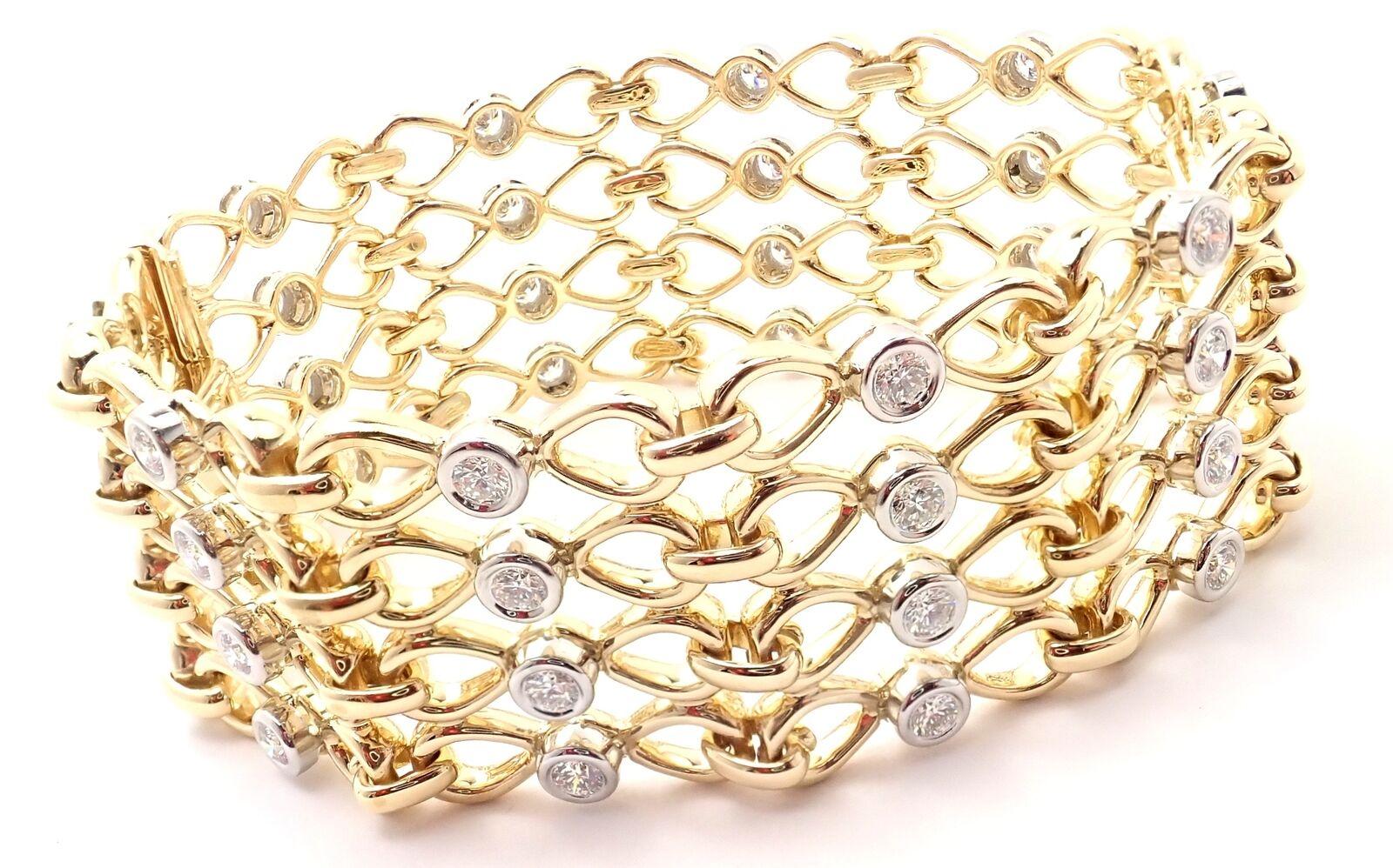 18k Yellow And Platinum Diamond Link Bracelet by Tiffany & Co.
With 40 Round brilliant cut diamonds VS1 clarity, G color total weight approximately 3.20ct
Details:
Weight: 75.1 grams
Length: 7