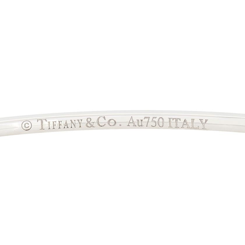 From Tiffany & Co.'s 'Metro' collection comes this beautiful diamond set bangle. A total of 0.73 carat in round brilliant diamonds are micro set across the front half of the bangle. Each diamond is of matching quality at F in colour and VVS in