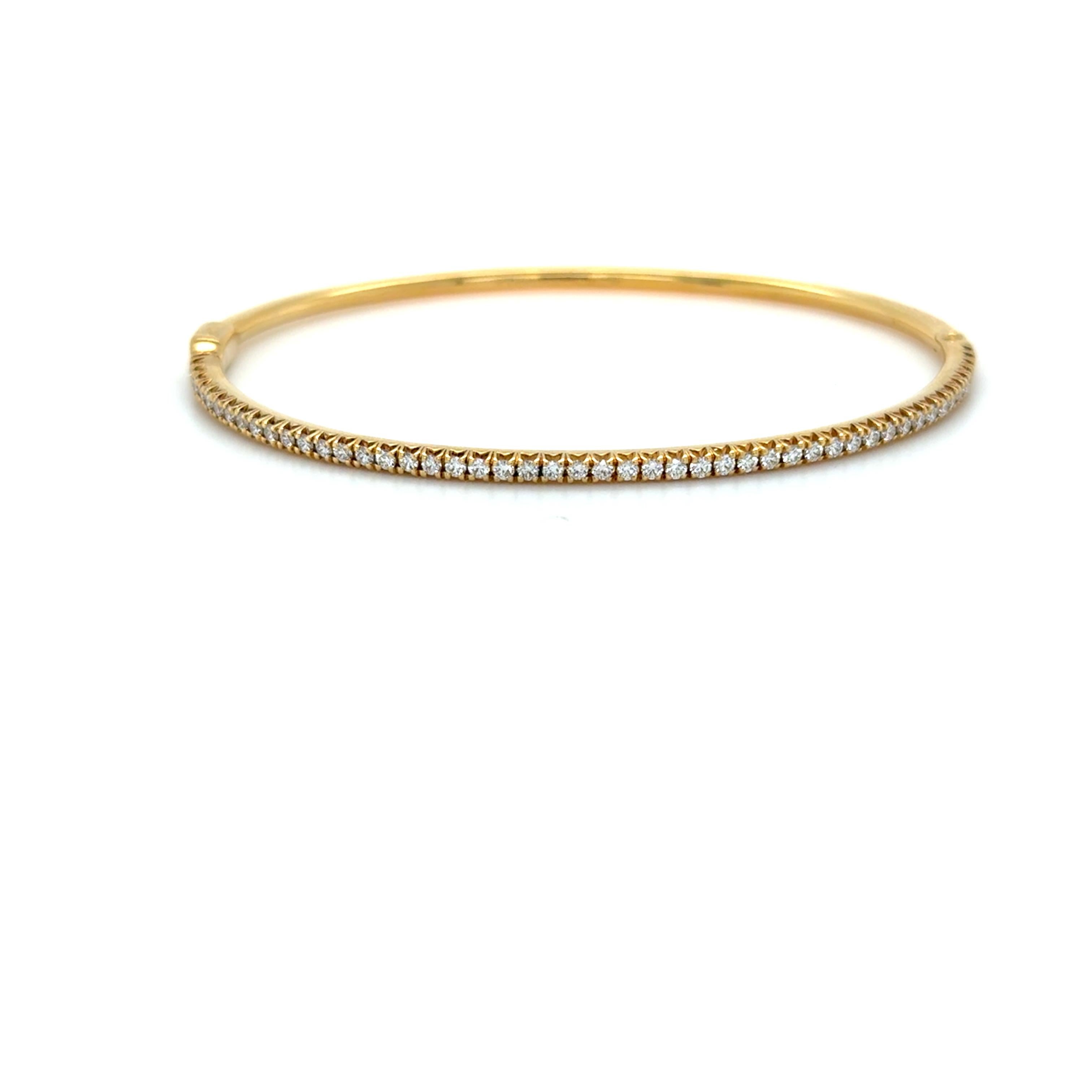This classic Tiffany & Co. bangle is part of the Metro collection and contains 0.67 carats of top quality round brilliant cut diamonds. In the medium size and hinged with a side clasp and mounted in 18 karat yellow gold. 

Accompanied by a Tiffany &