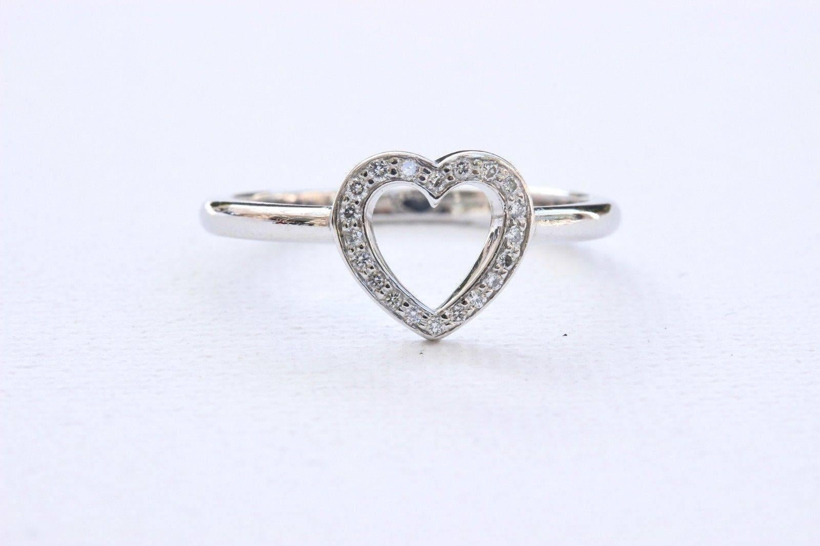 Tiffany & Co.
Style:  Open Heart Ring with Diamonds
Metal:  Platinum PT950
Size:  6.75 - sizable
Total Carat Weight:  0.11 TCW
Diamond Shape:  Round Brilliant Diamonds 0.11 TCW
Diamond Color & Clarity:  F - G / VS
Hallmark:  ©Tiffany&Co.