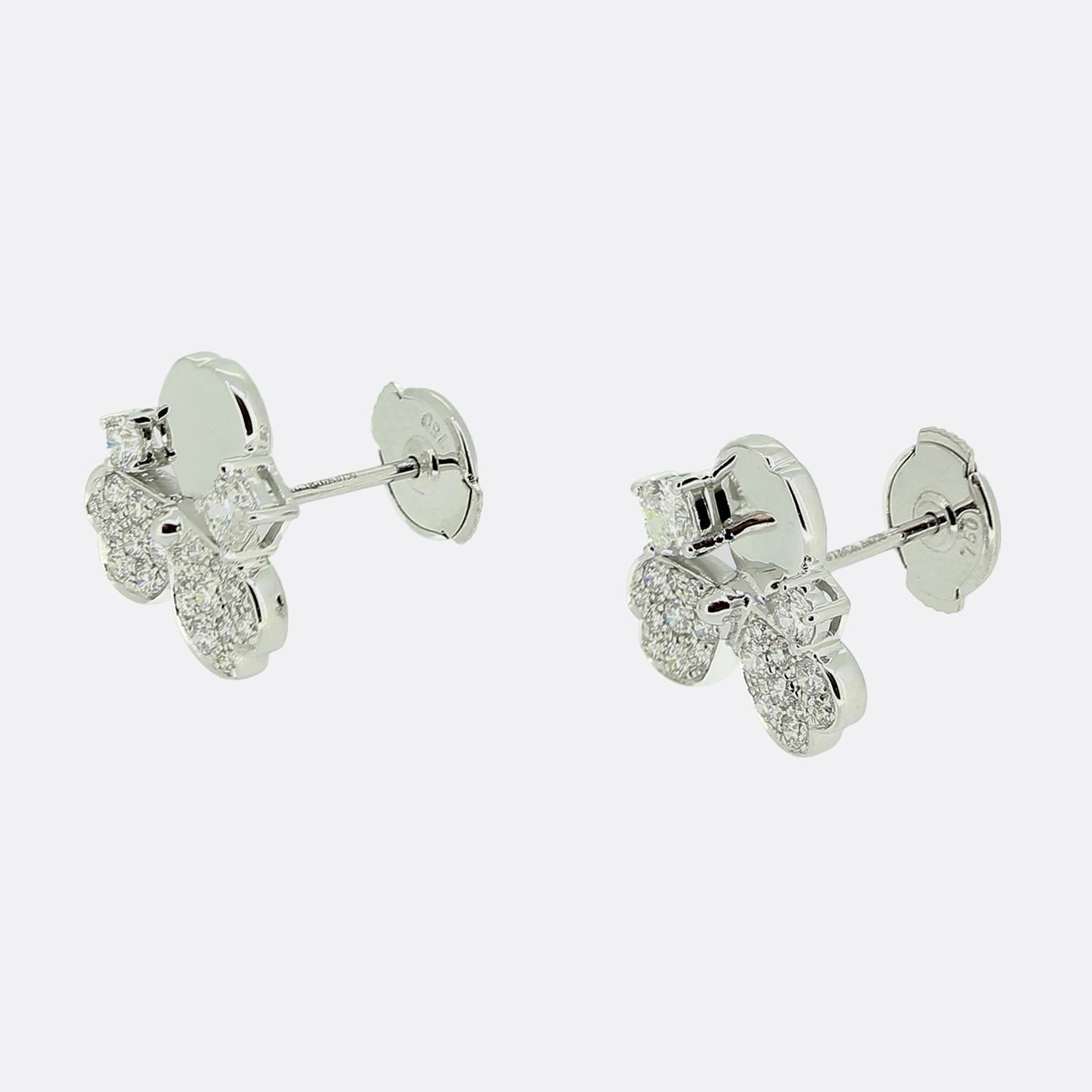 Here we have a charming pair of earrings from Tiffany & Co. Each identical piece has been crafted from 18ct white gold and showcases a flower motif with three petals; two of which have been pavé set with a total of eighteen round brilliant cut