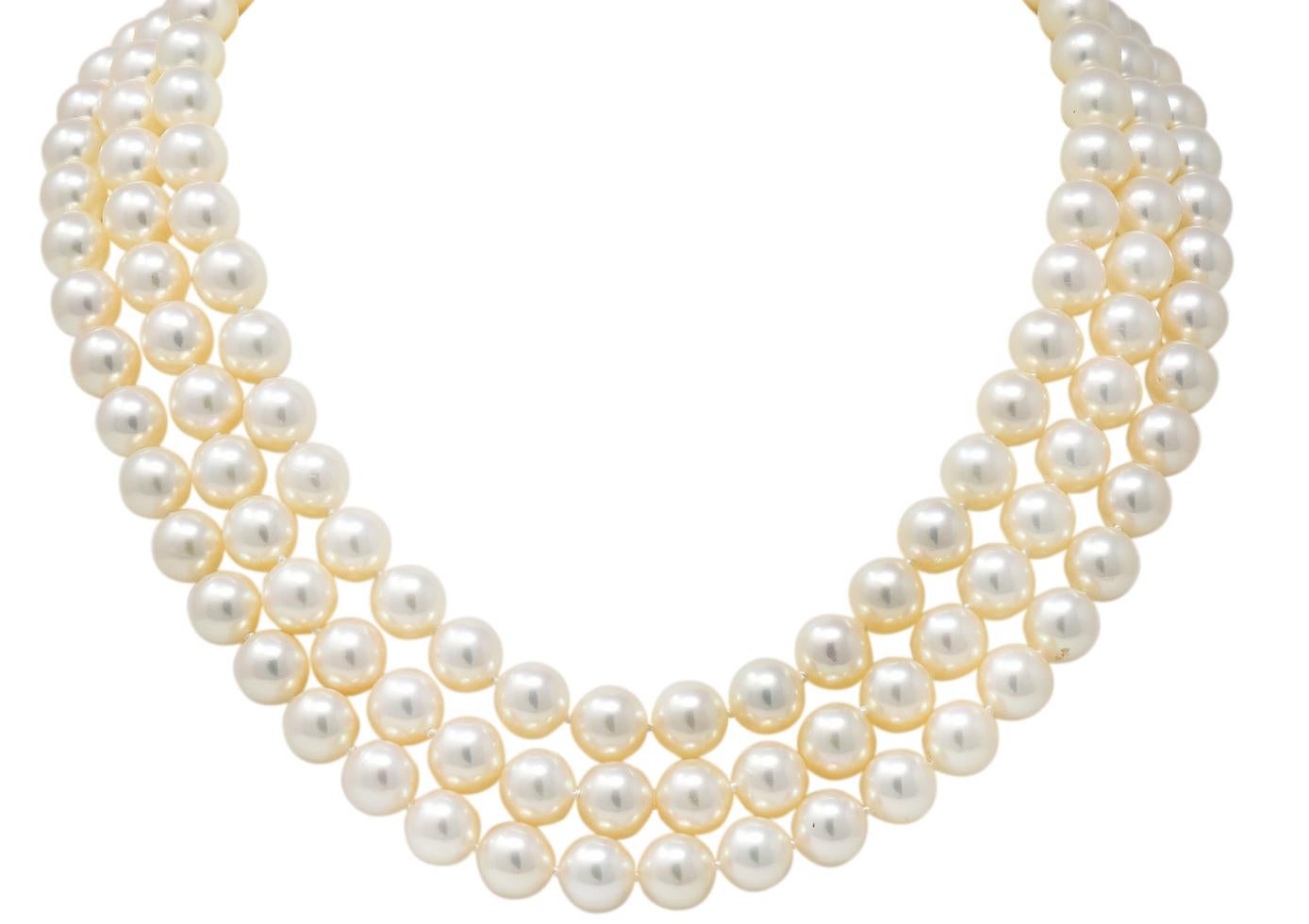 Designed as a hand-knotted three strand necklace with round natural freshwater cultured pearl beads measuring approximately 8.8 mm

Cream in body color with silver and some rosé overtones, very well matched

With a scalloped gold bar separating two