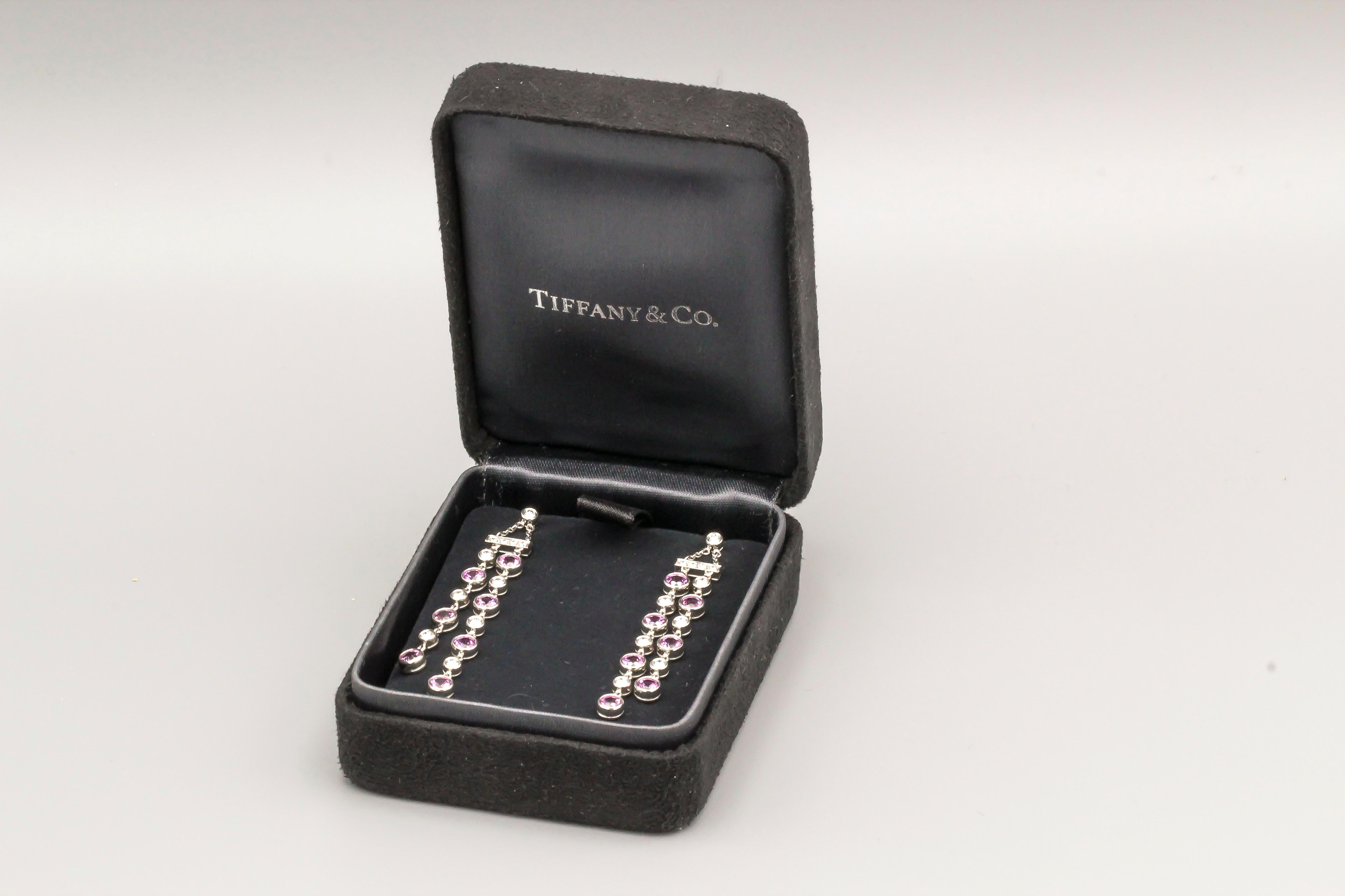 Elegant diamond, pink sapphire and platinum ear pendants from the 
