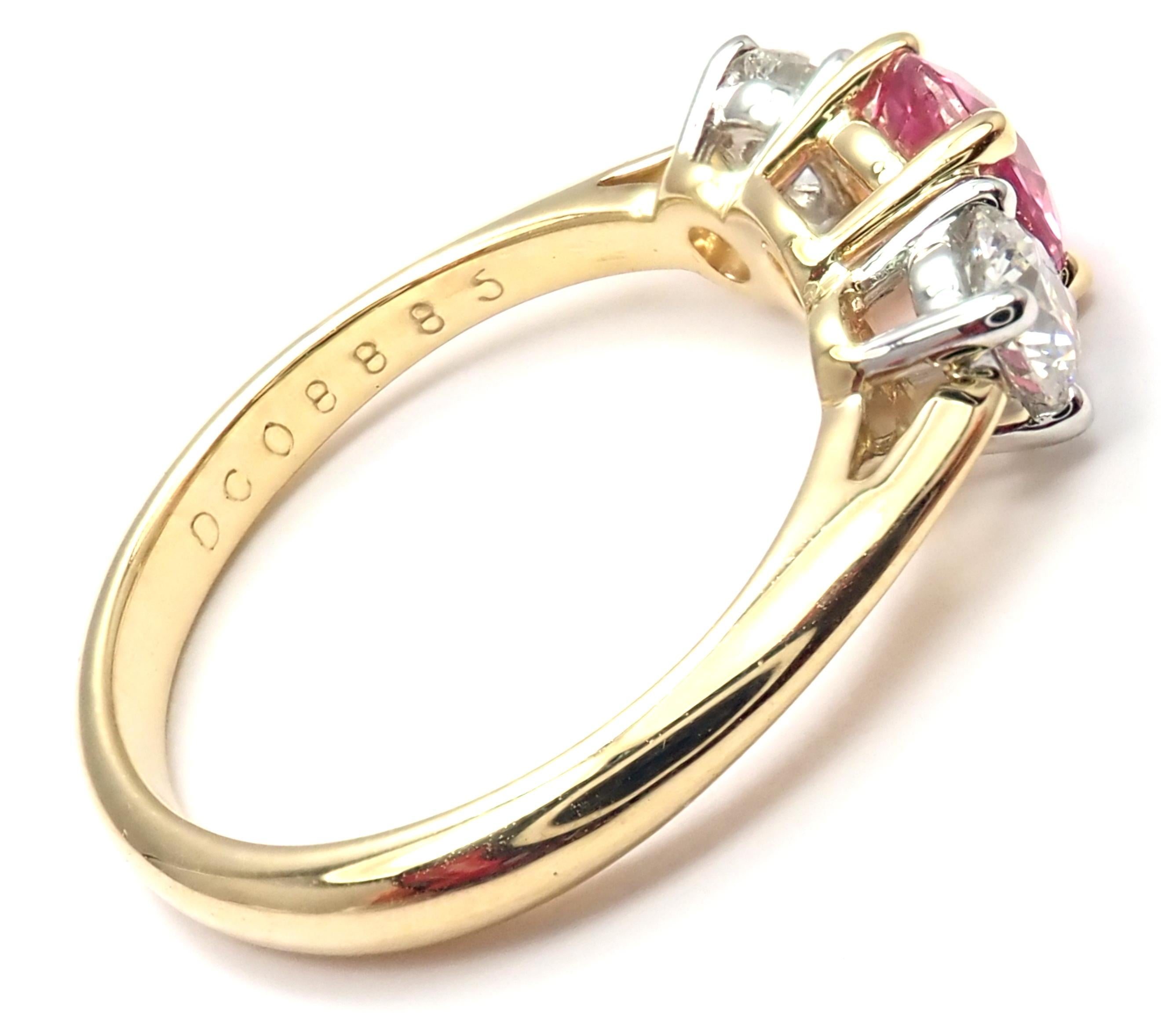 18k Yellow Gold And Platinum Diamond Pink Sapphire Three Stone Band Ring.
With 2 Round Brilliant Cut Diamonds VS1 clarity, G color, Total weight Approx .50ctw
1 Round Pink Sapphire total weight approx.  0.60ct
Measurements:
Ring Size: 4 3/4
Weight:
